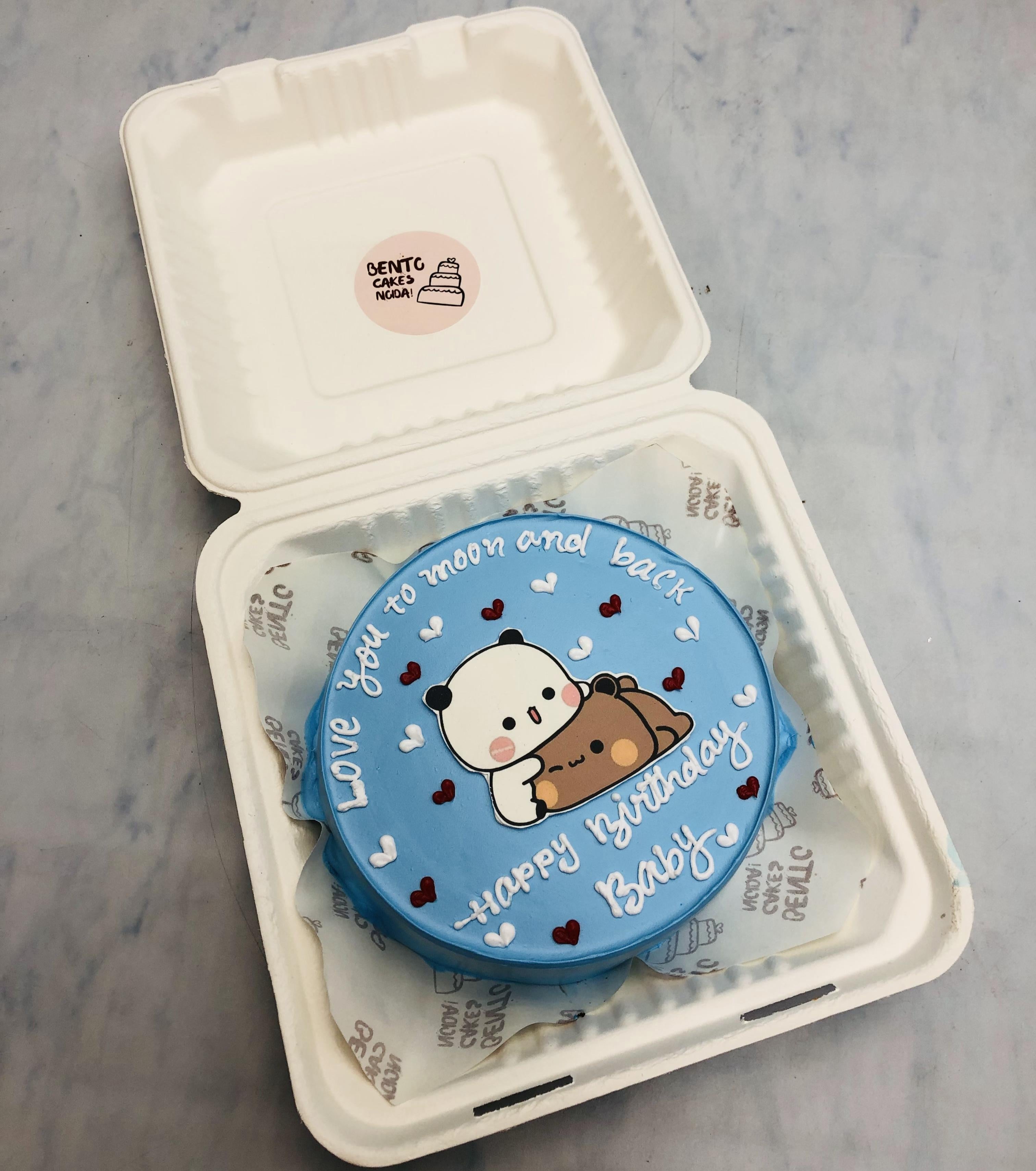 A light blue bento cake having loving bubu dudu cartoon print for lovers birthday.