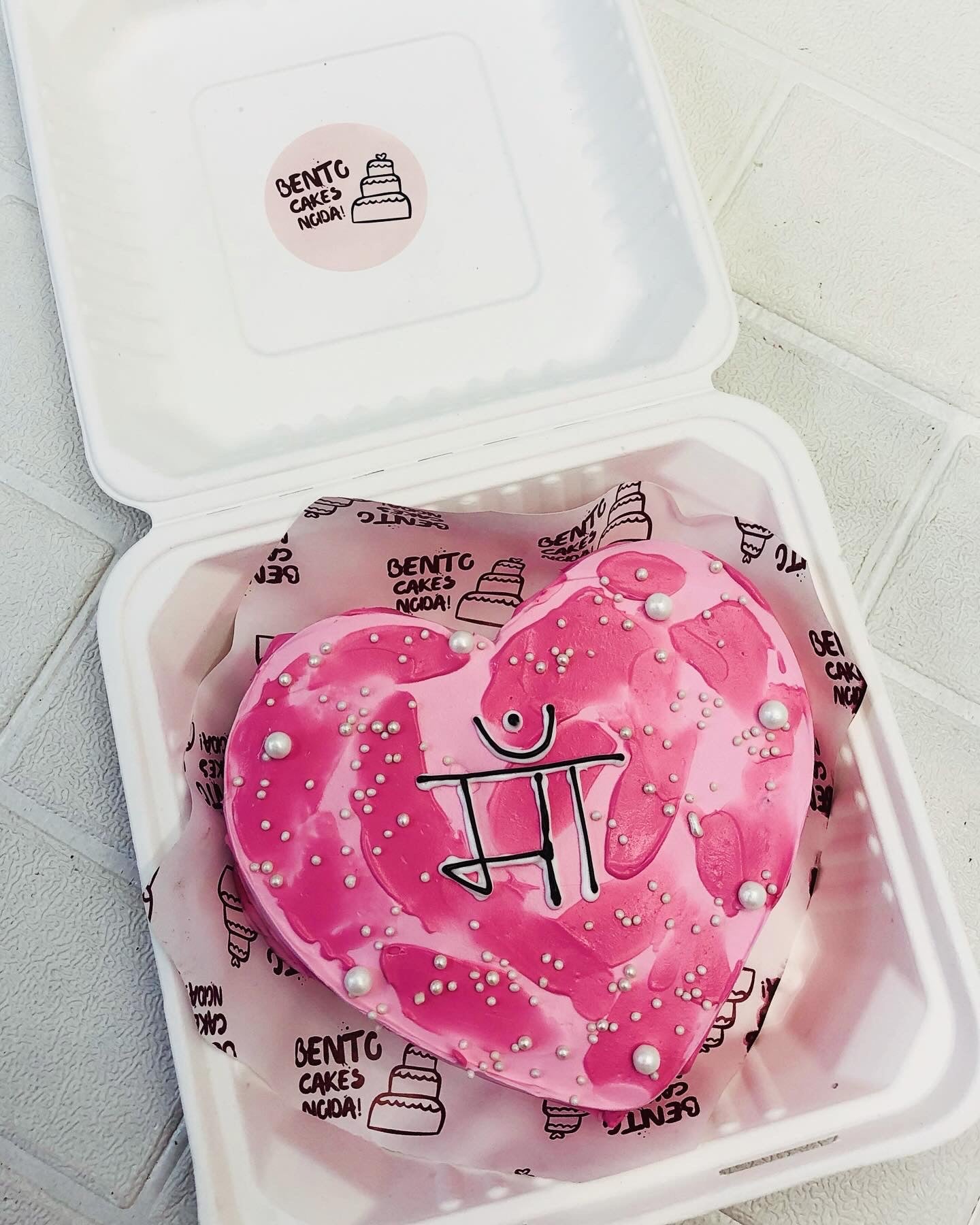 Aestheticpink shades heart shape cake showing love and affection for mother.