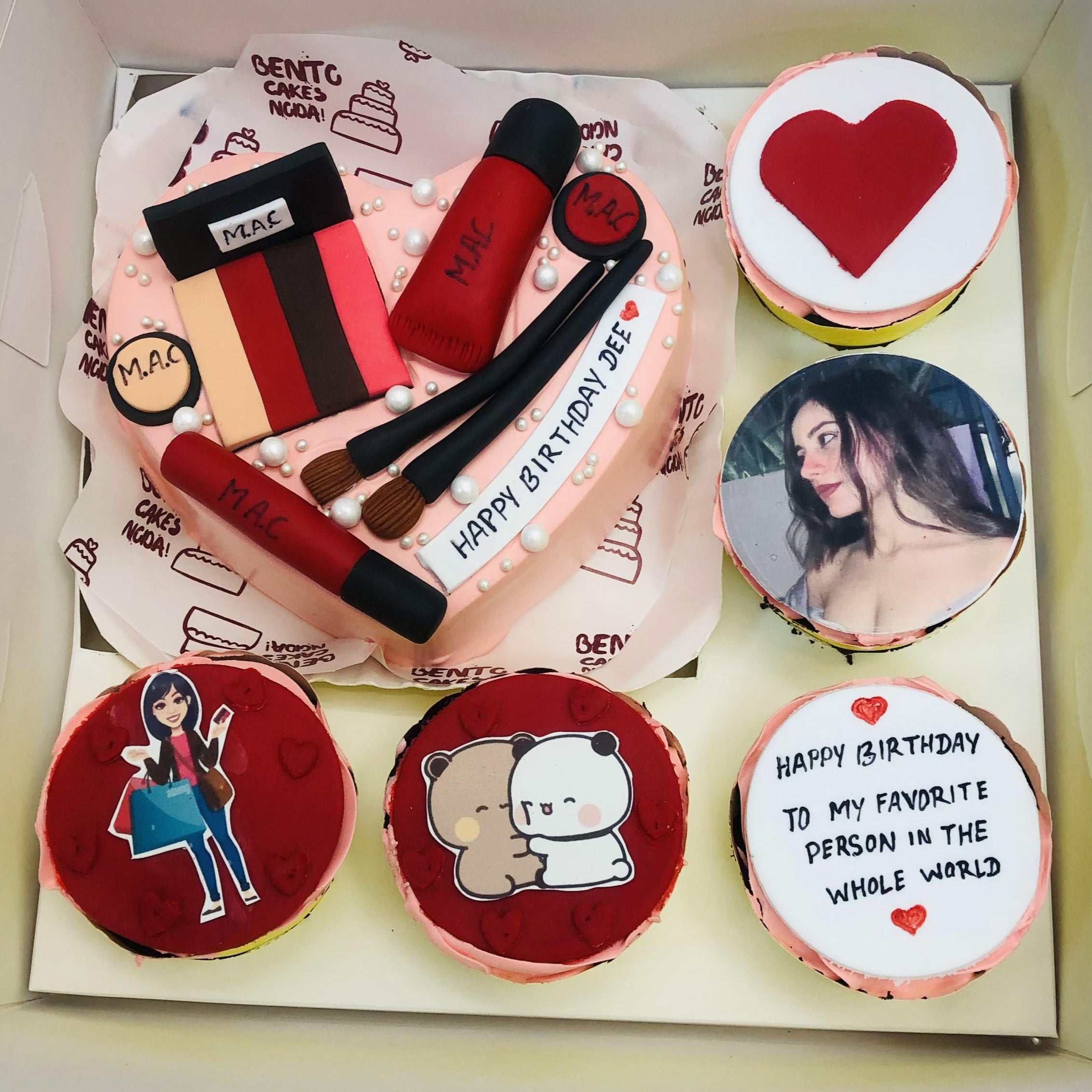 A bento combo cake set featuring a heart-shaped cake decorated with M.A.C makeup items and a message 'HAPPY BIRTHDAY DEE,' alongside five smaller cakes with unique designs, including a heart, illustrations, and a birthday message.