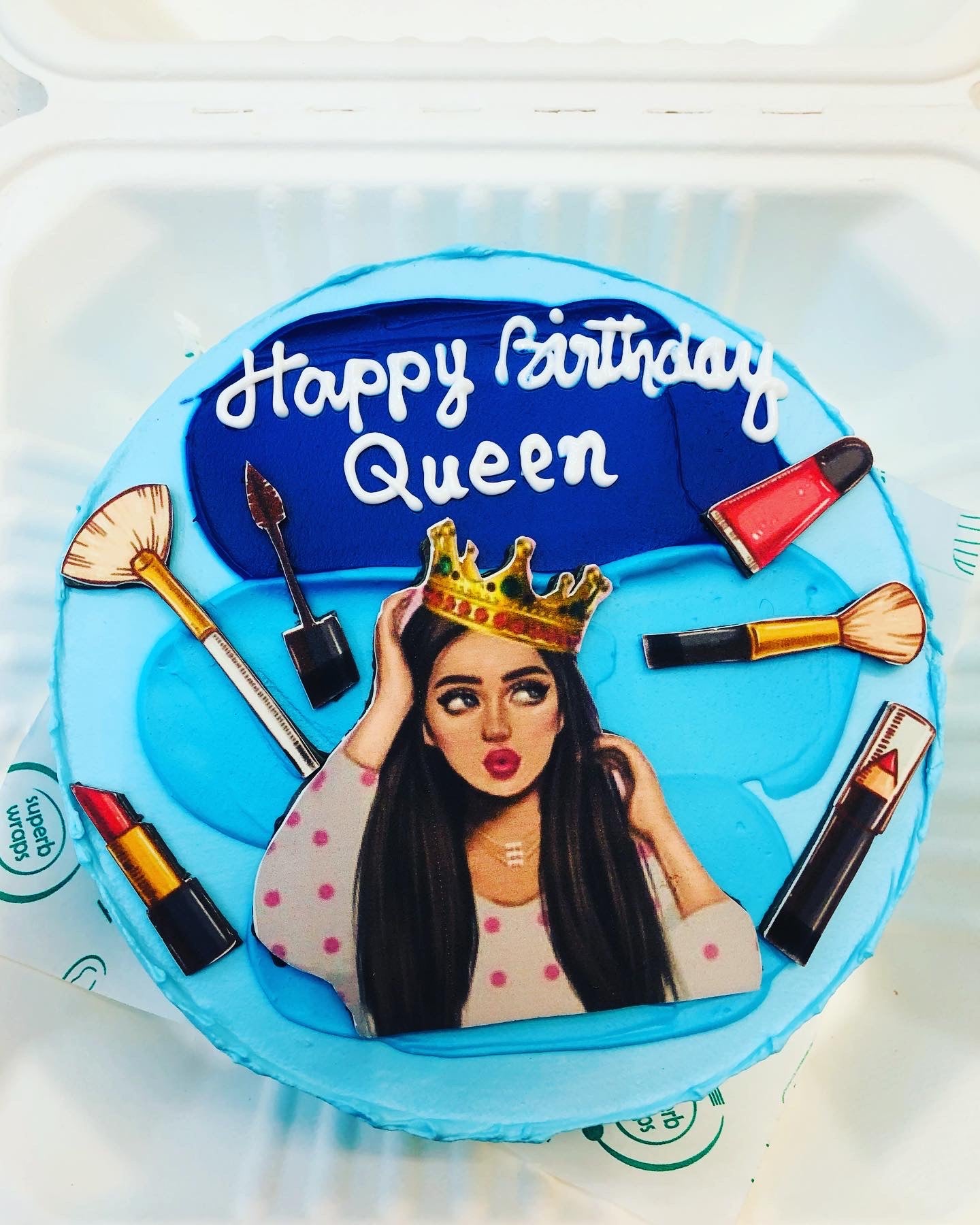 A skyblue bento cake is designed for makeup lovers girl with a girl and makeup kit print.