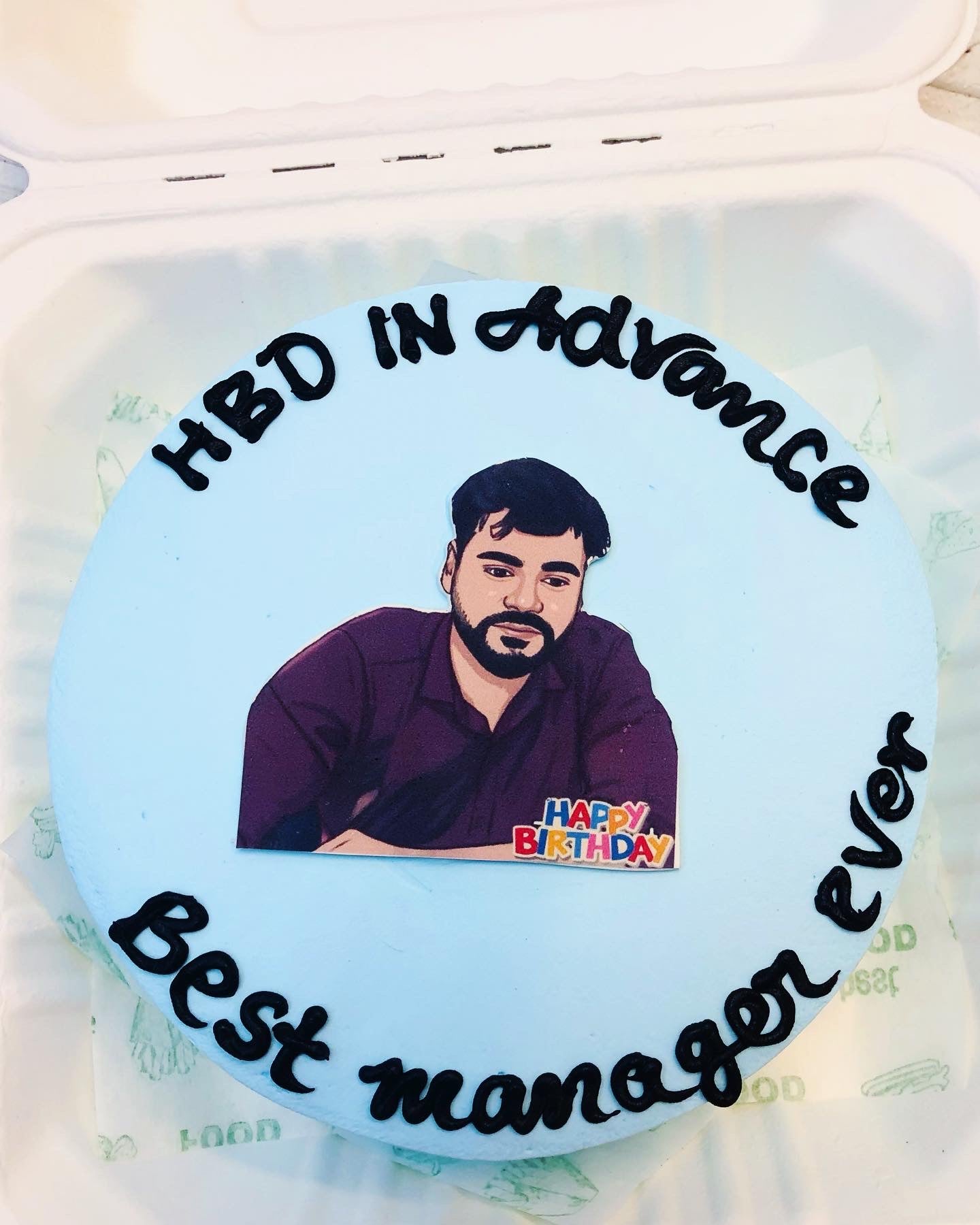 A decorated cake displaying a printed image of a man, perfect for celebrating a memorable event.