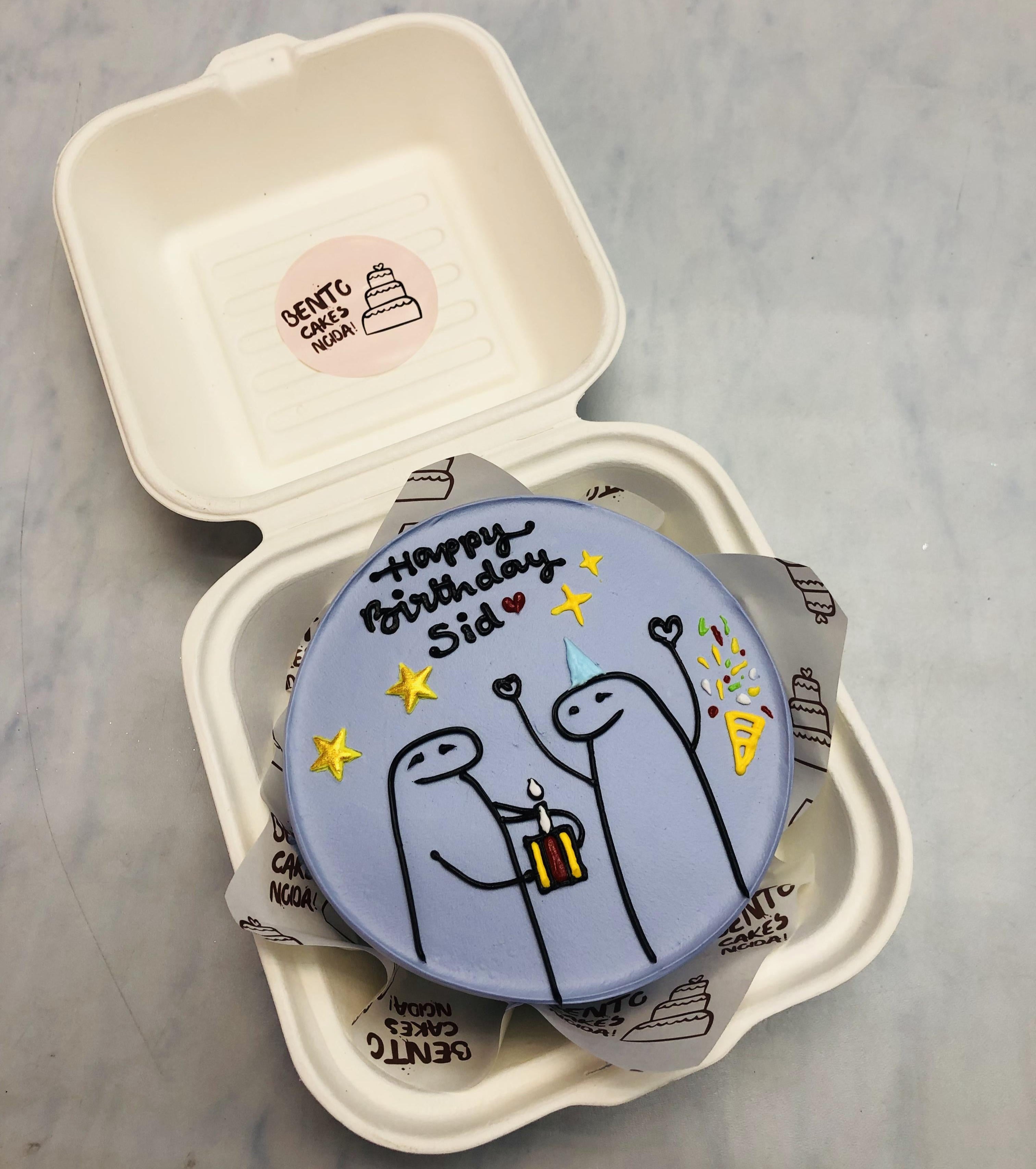 A light blue mini cake in a mini bento box having 2 mimi character celebraing birthday.