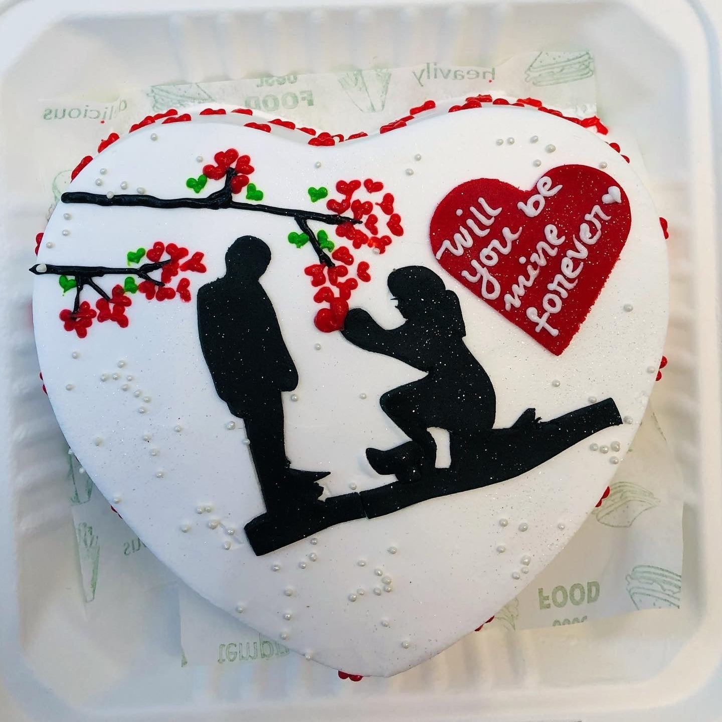 A festive birthday cake featuring a decorative car on top, celebrating a special occasion with vibrant colors.