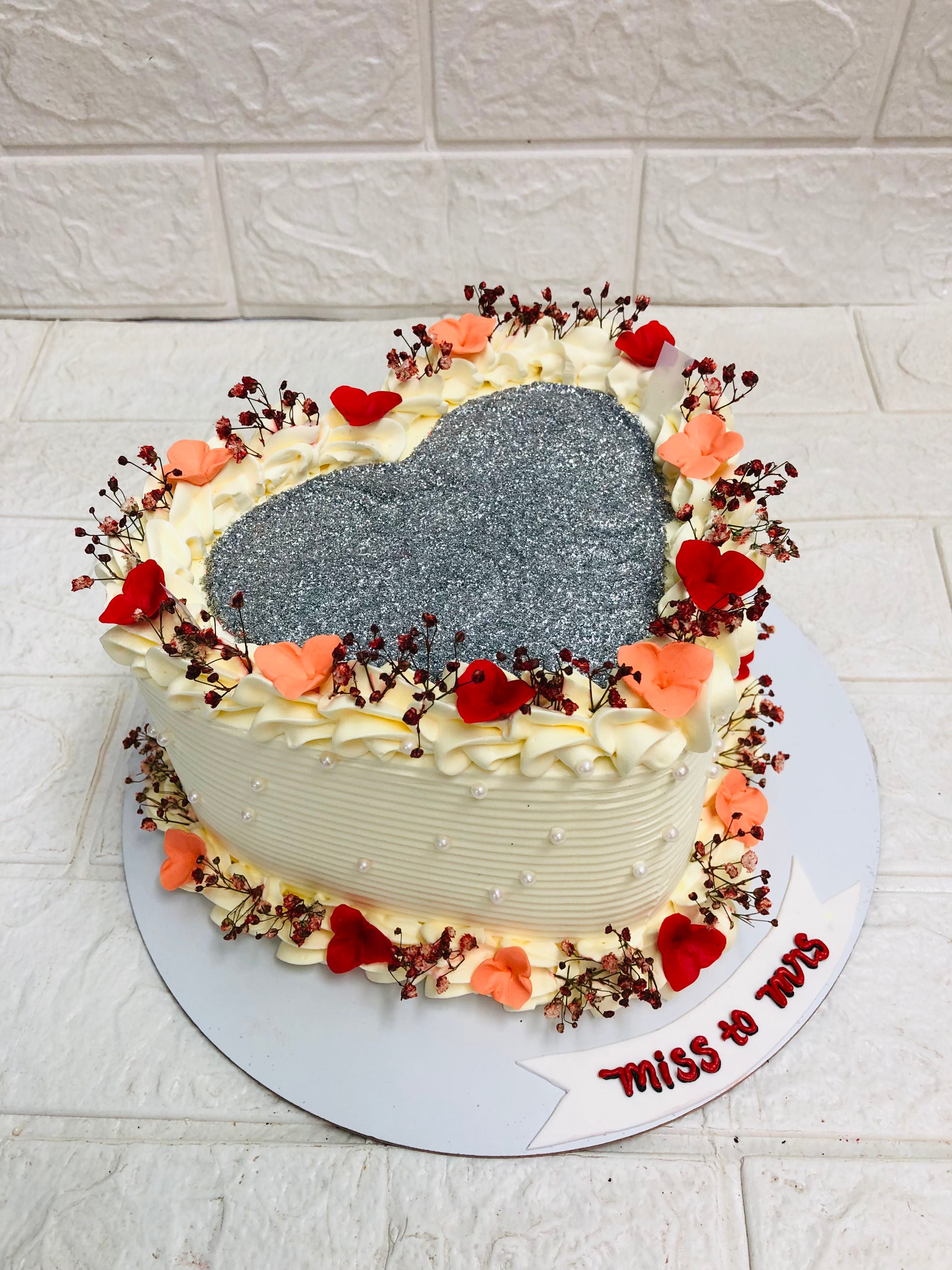 A heart-shaped cake adorned with a smaller heart on top, symbolizing love and affection in a delightful dessert.