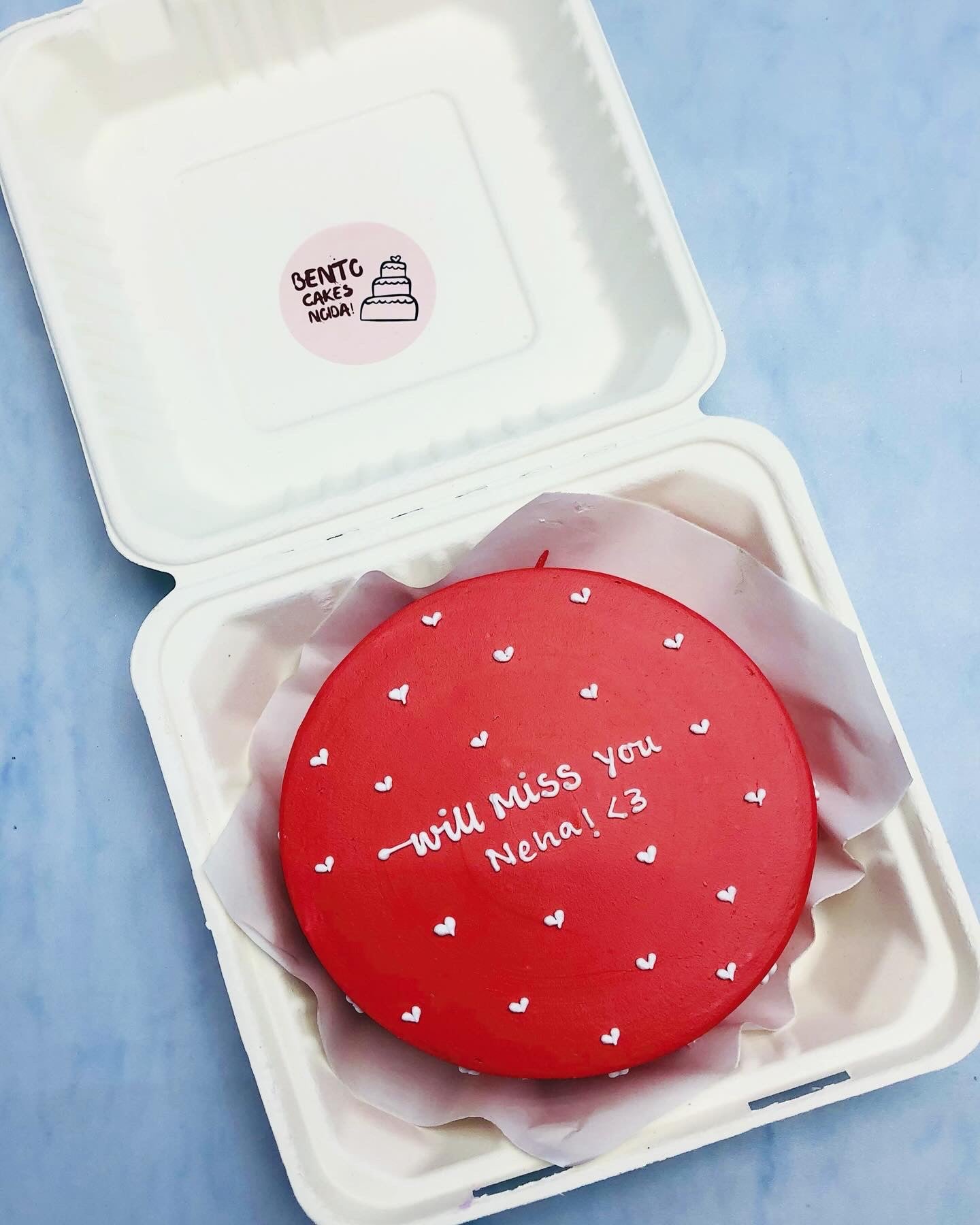 A dark red bento cake is designed on missing theme.