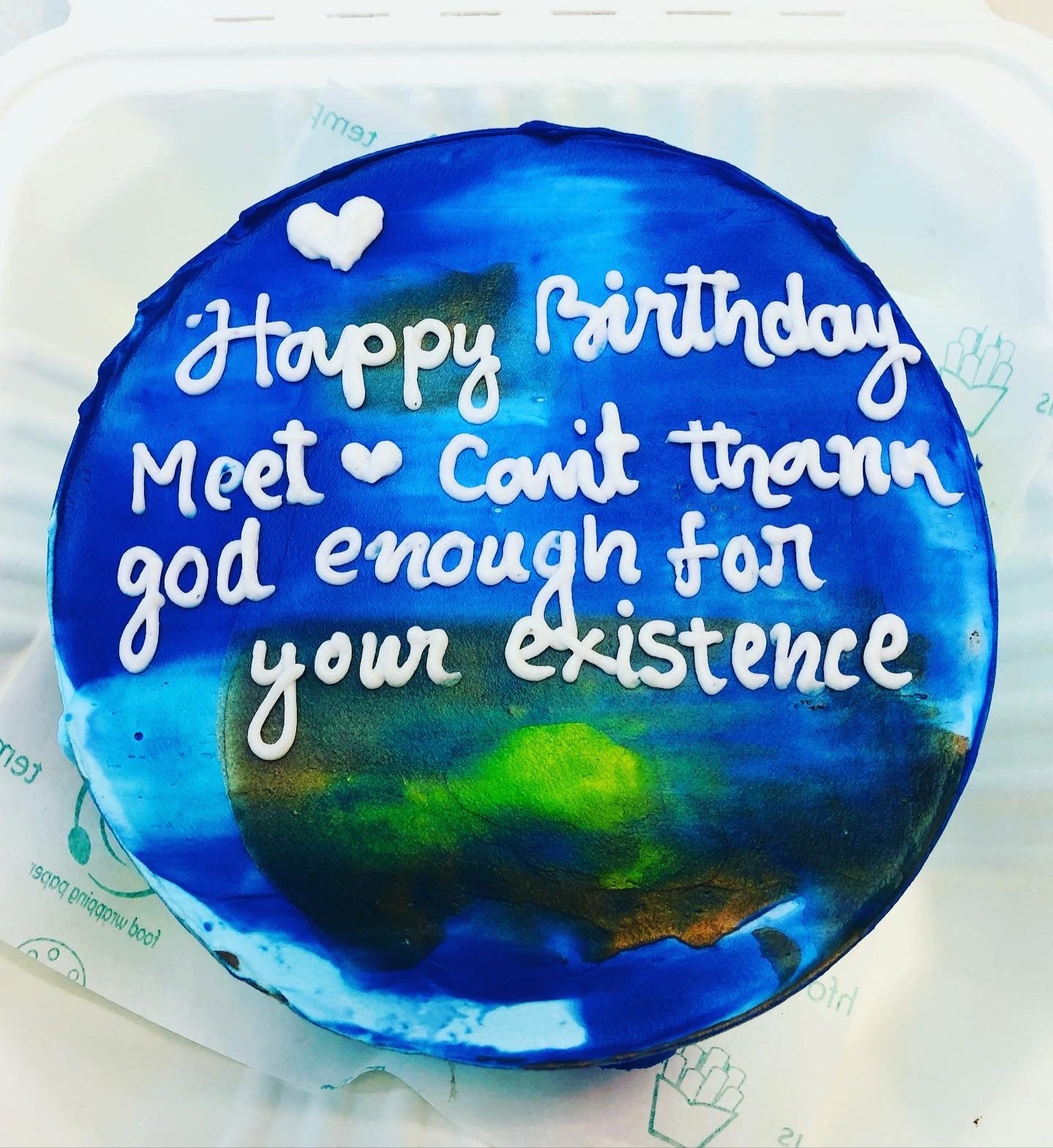 A dark night theme bento cake decorated with multiple colors and a text witten with white icing.