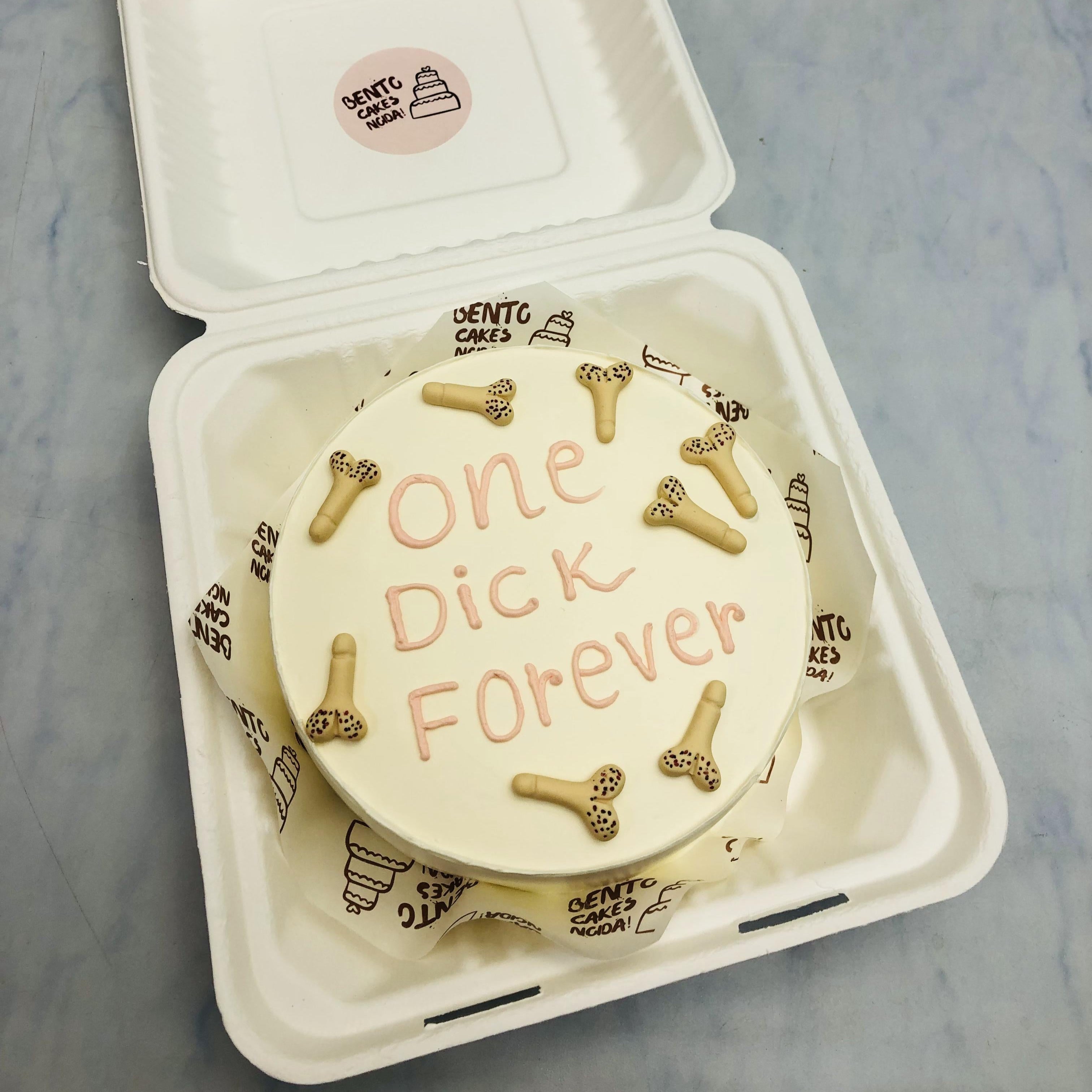 A white bento cake having dich designs all over the cake with a bachelor text.