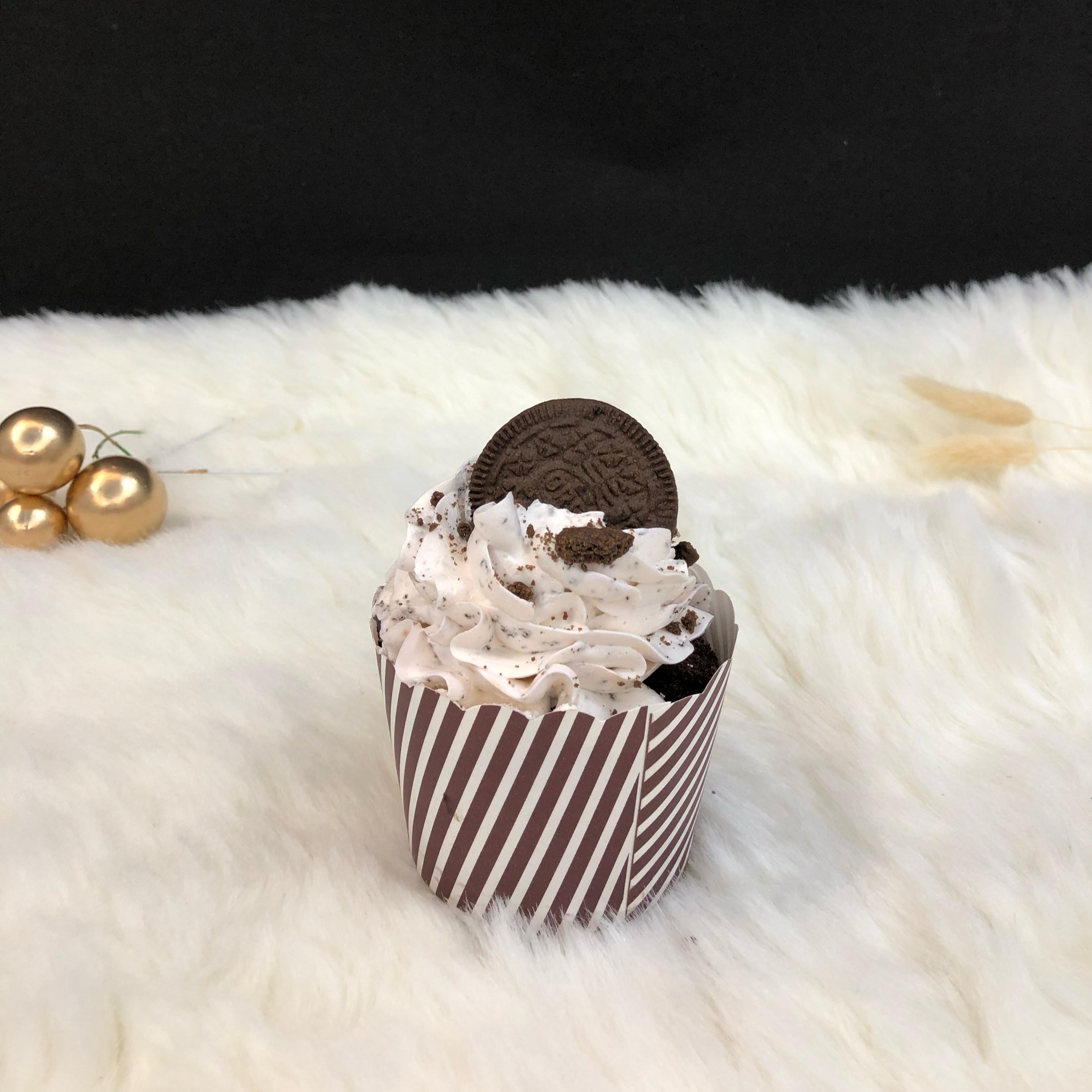 A cup filled with oreo flavour and ore biscuit.