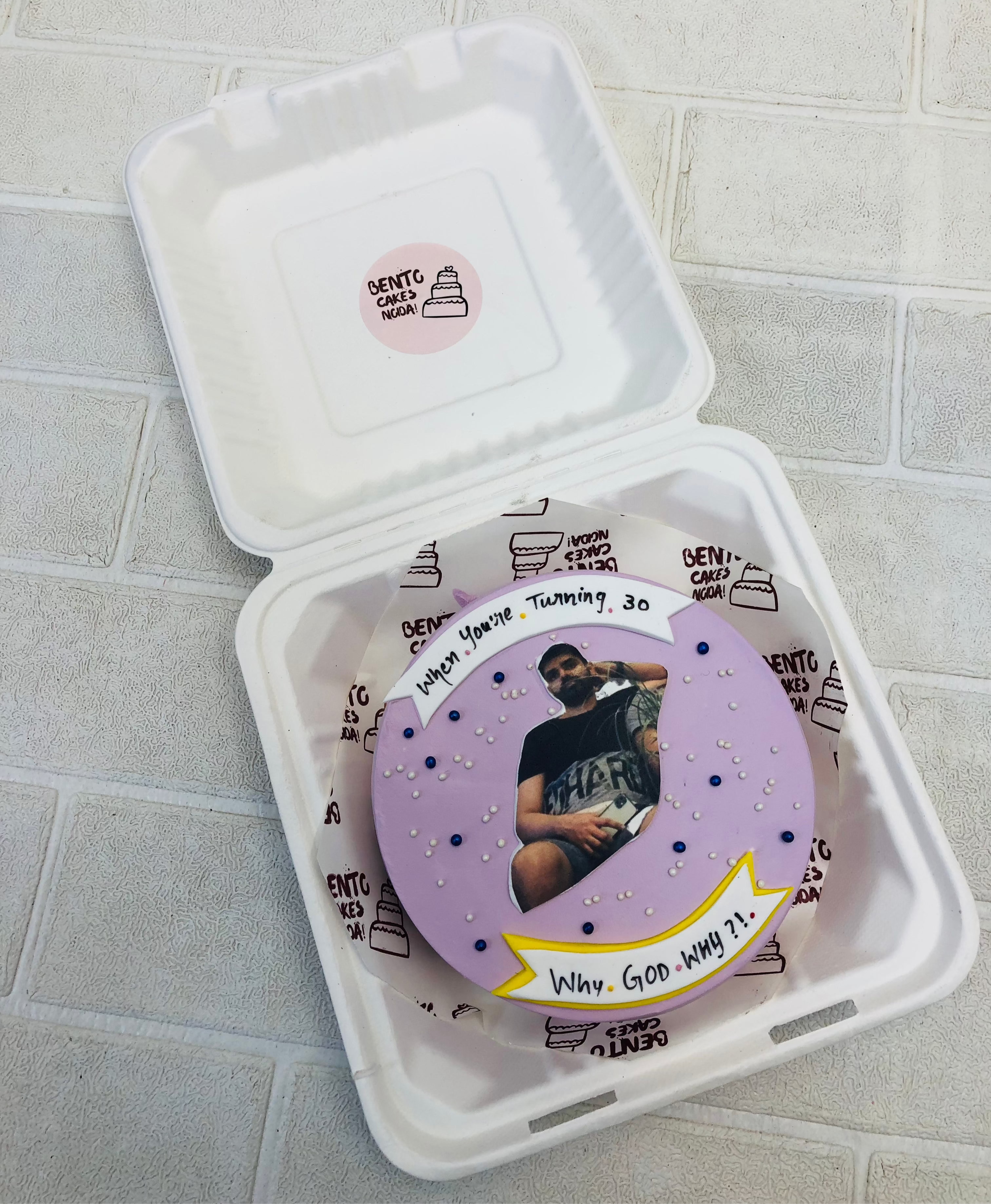 A light puple bento cake designed on friends theme with a men's photo.