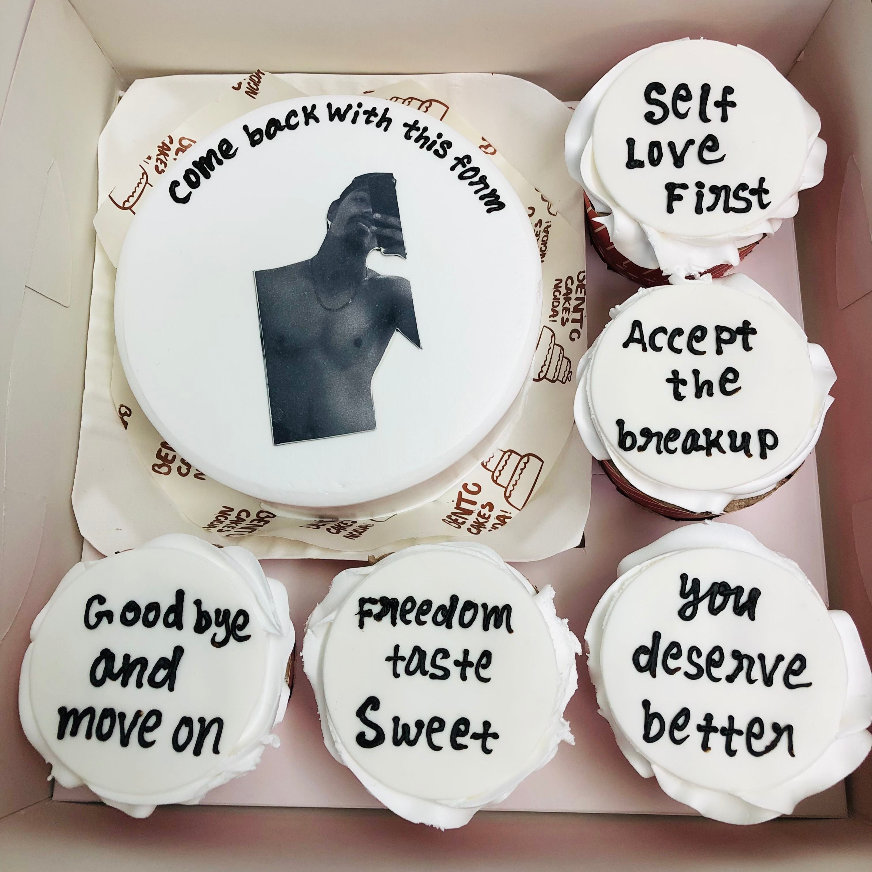 A box of 5 cupcakes set with a cake featuring an image of a man printed on the frosting of each cupcake.