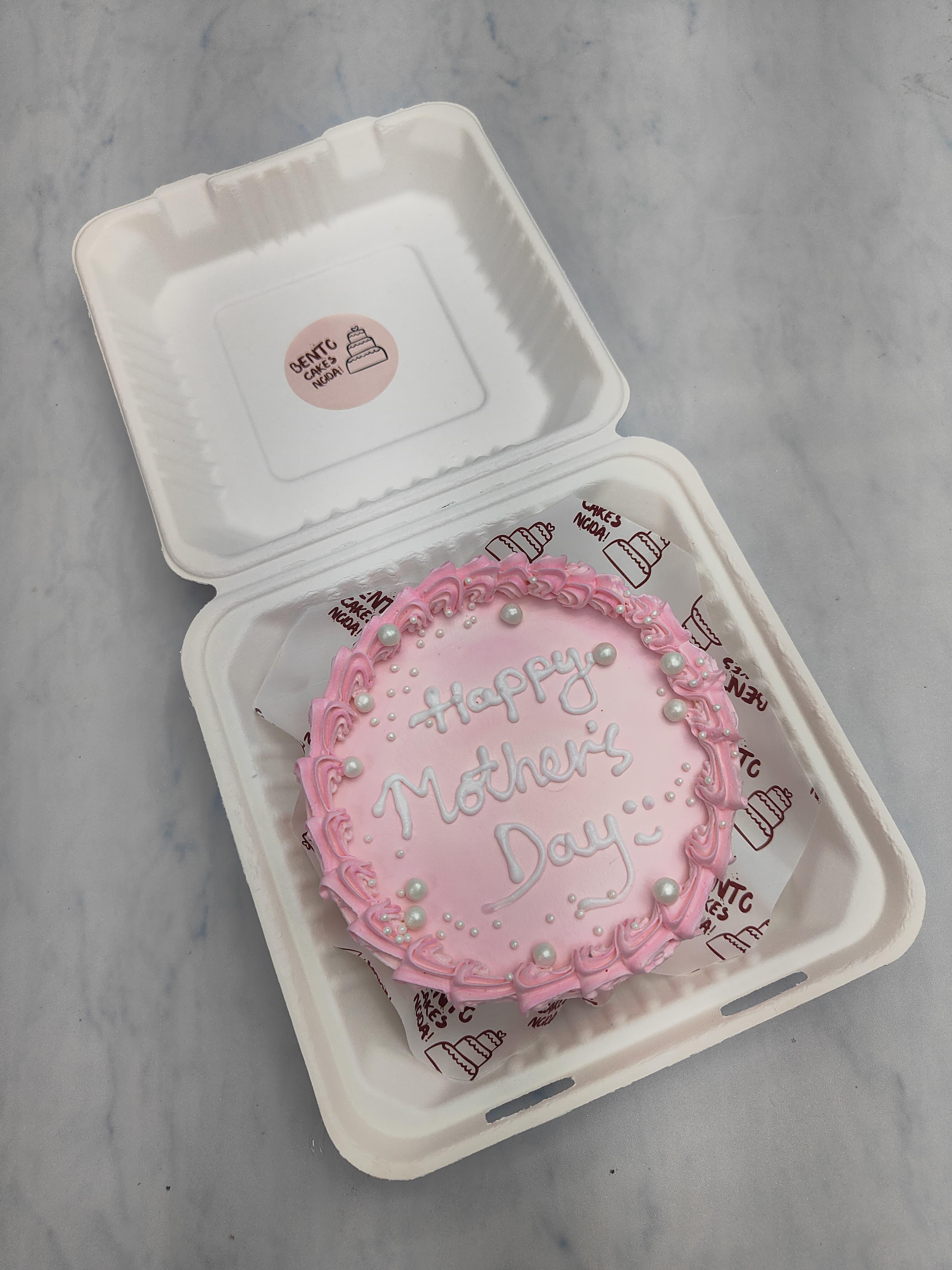 A light pink beautiful cake designed for mothers day occasion.