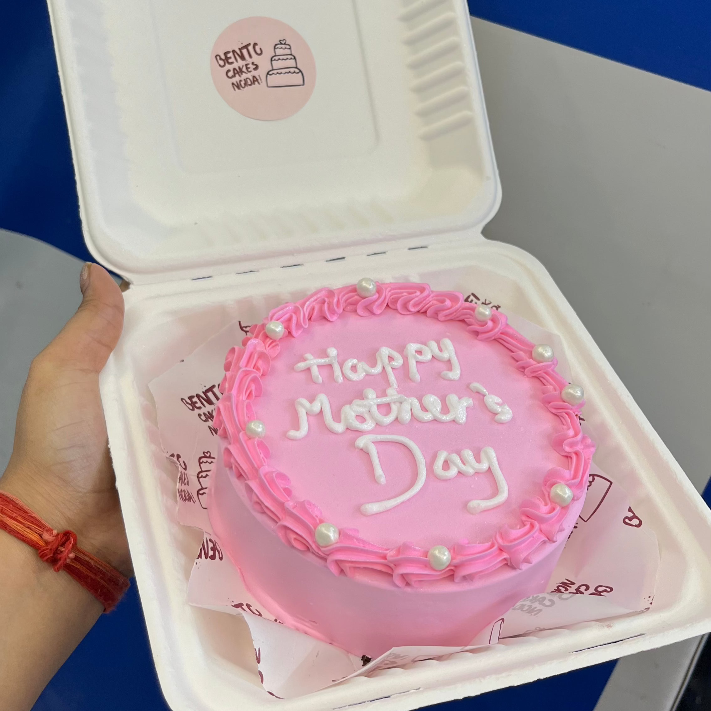 A baby pink bento cake is beautifully designed for mothers day.