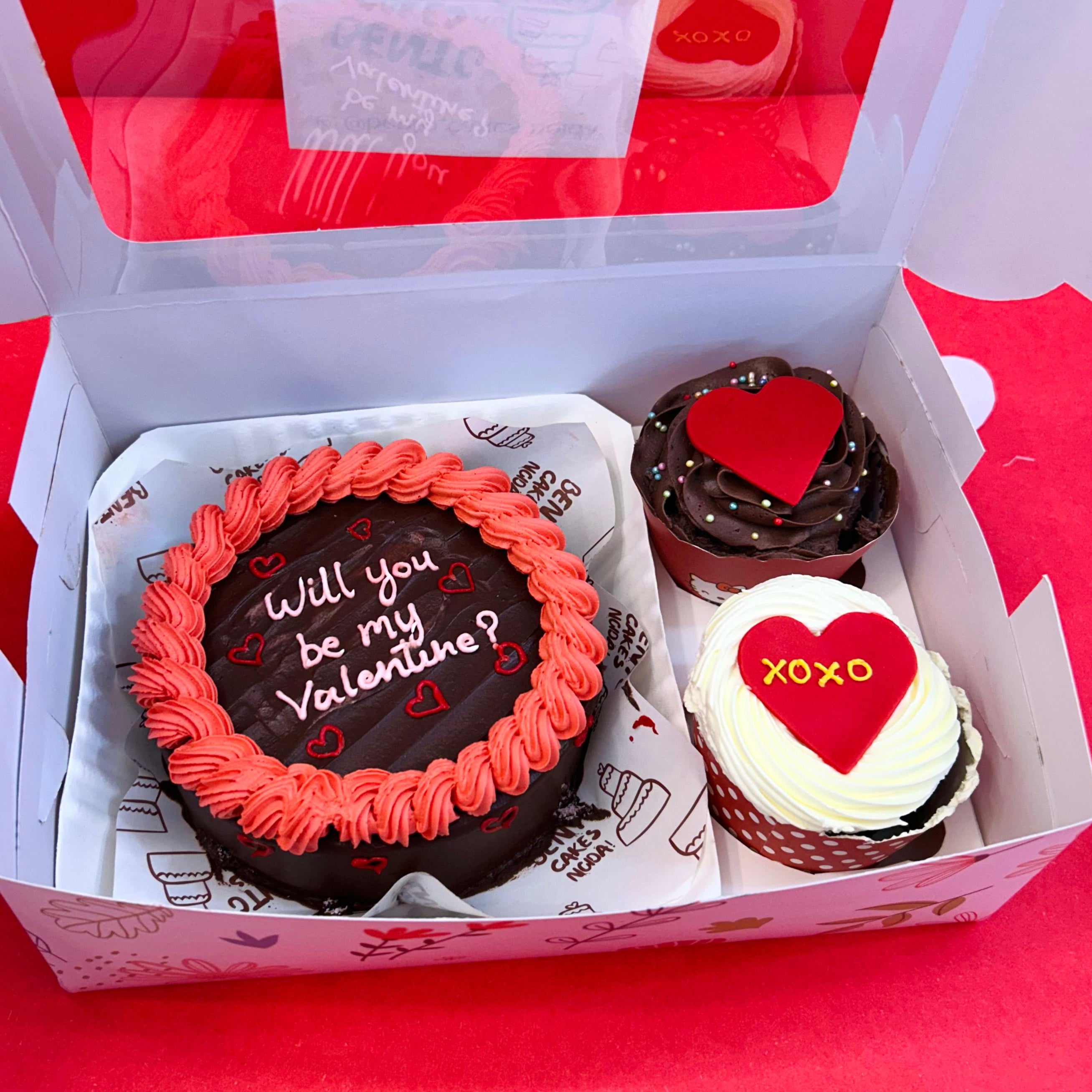 A delightful box showcasing a mini bento combo cake and cupcakes, all themed for Valentine's Day with a romantic message.