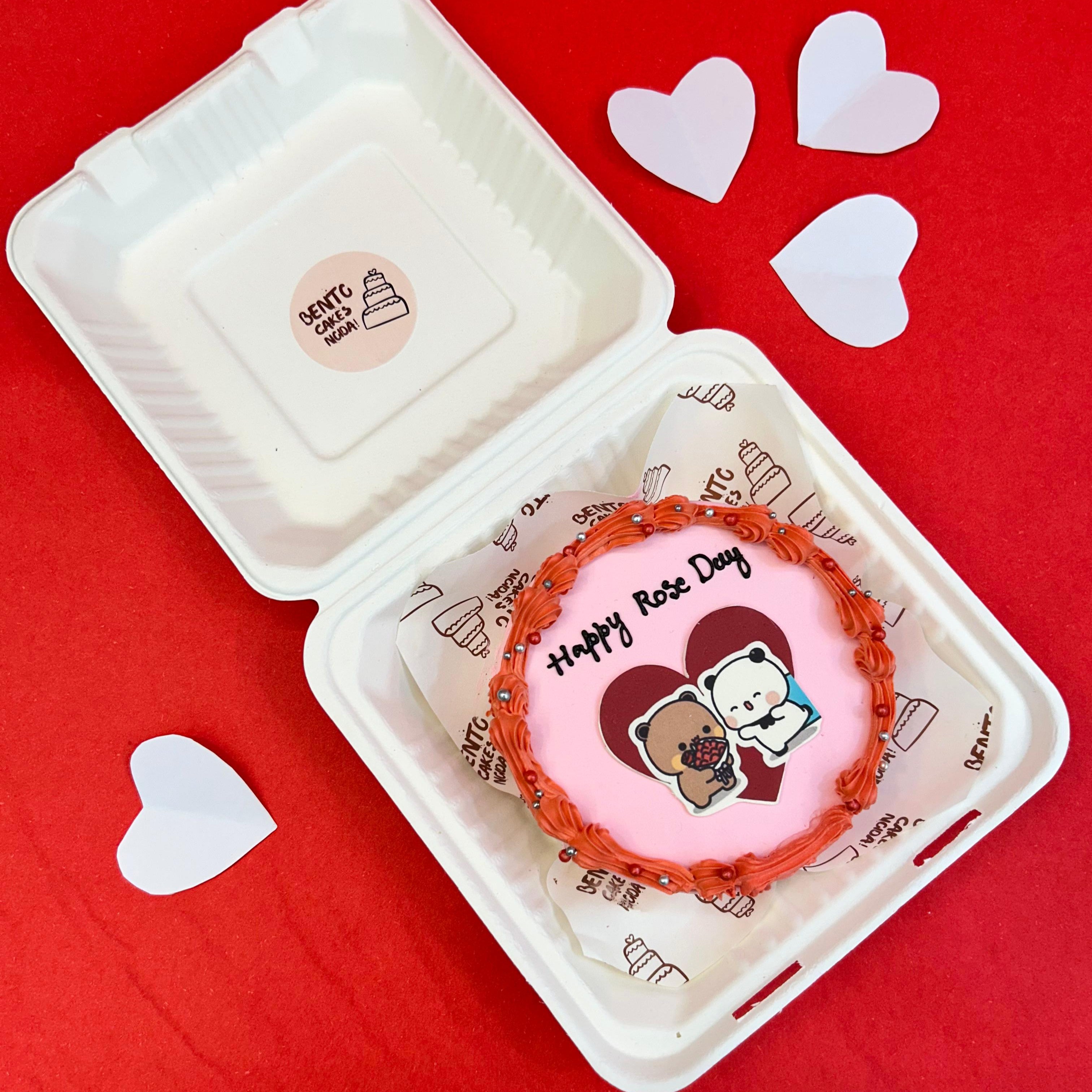 A delightful cake with a heart design, accompanied by the Bubu Dudu cartoon character, ideal for Rose Day festivities.