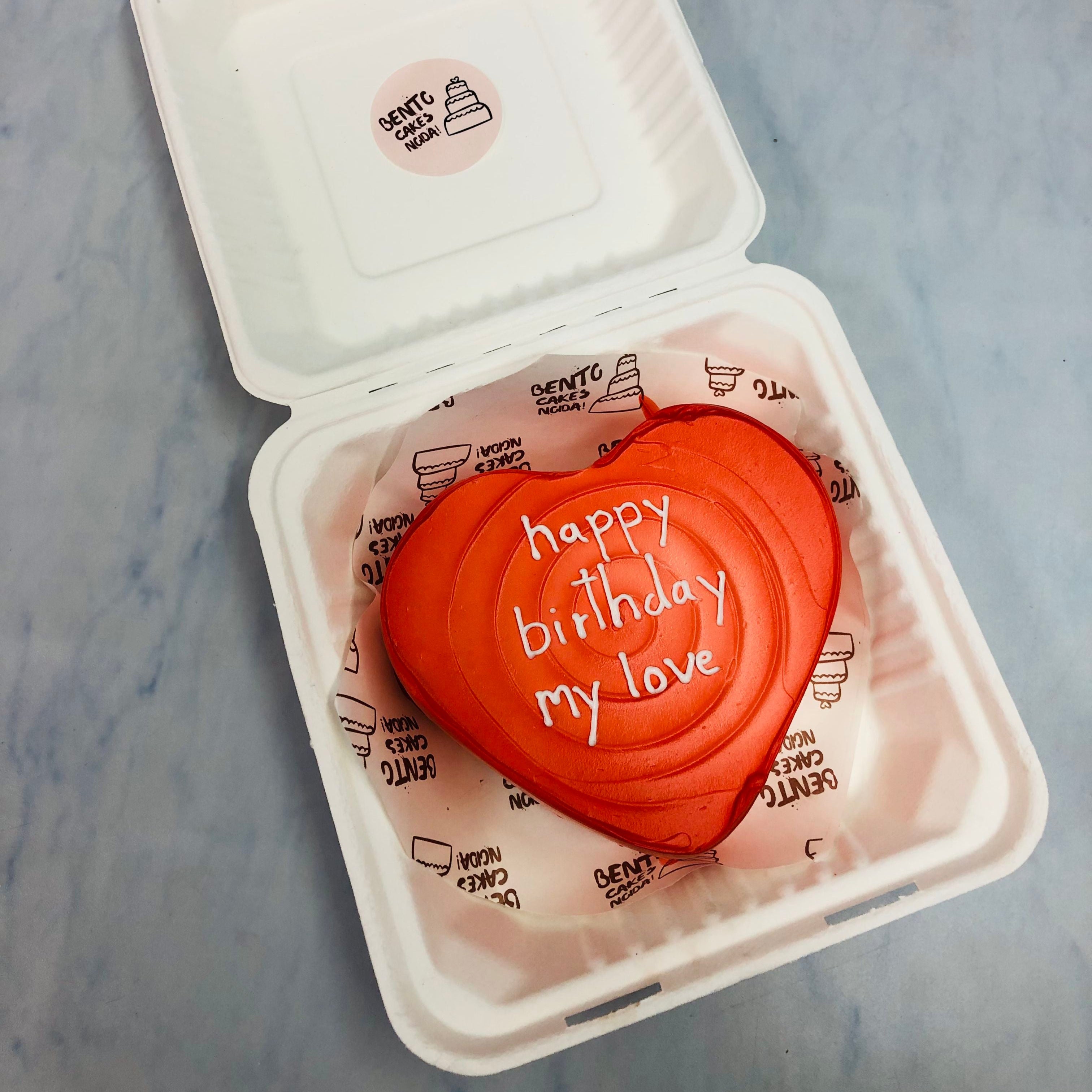 A dark red heart shape cake is designed for expressing you love.