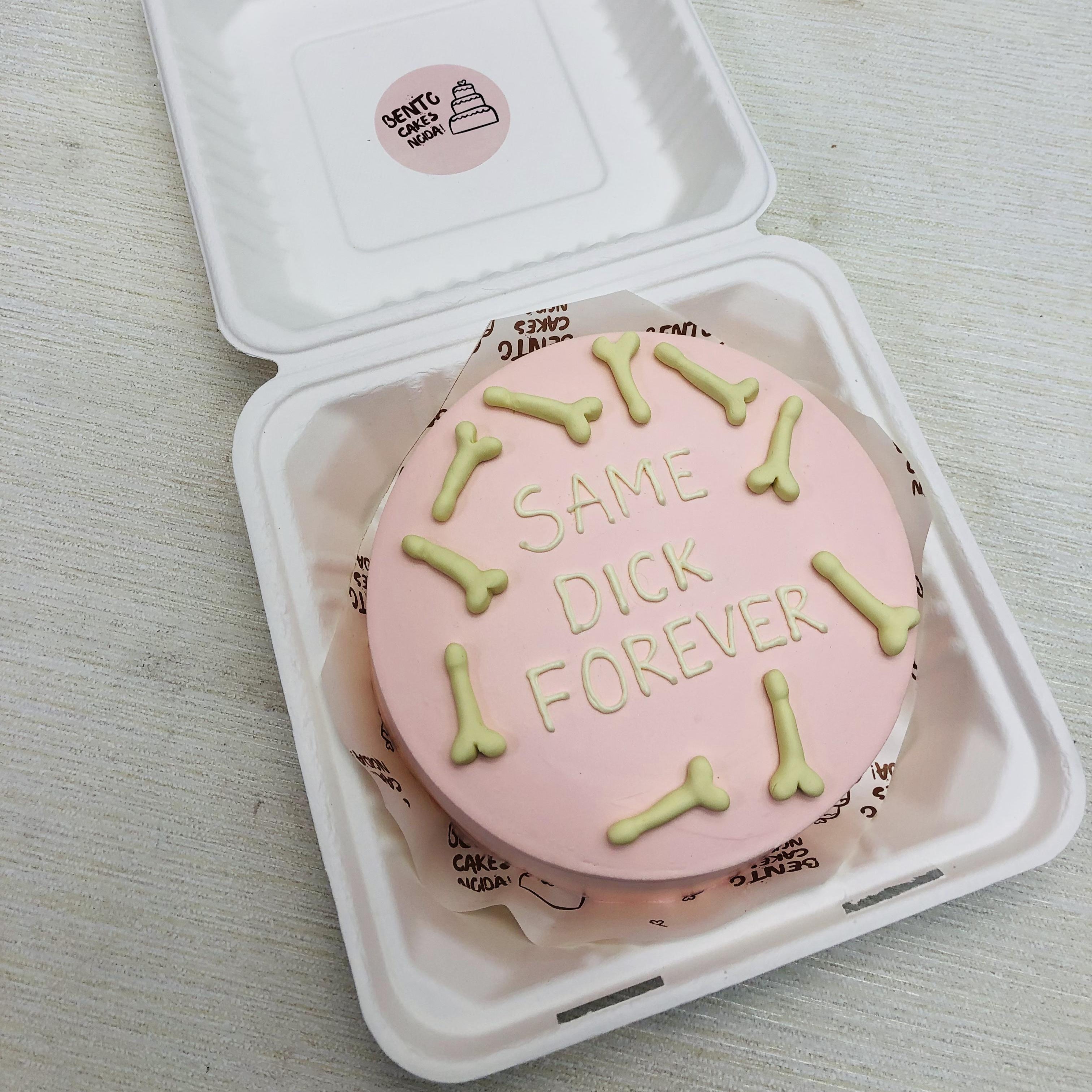 A light pink bento cake with fondant dick shapes all over the cake.
