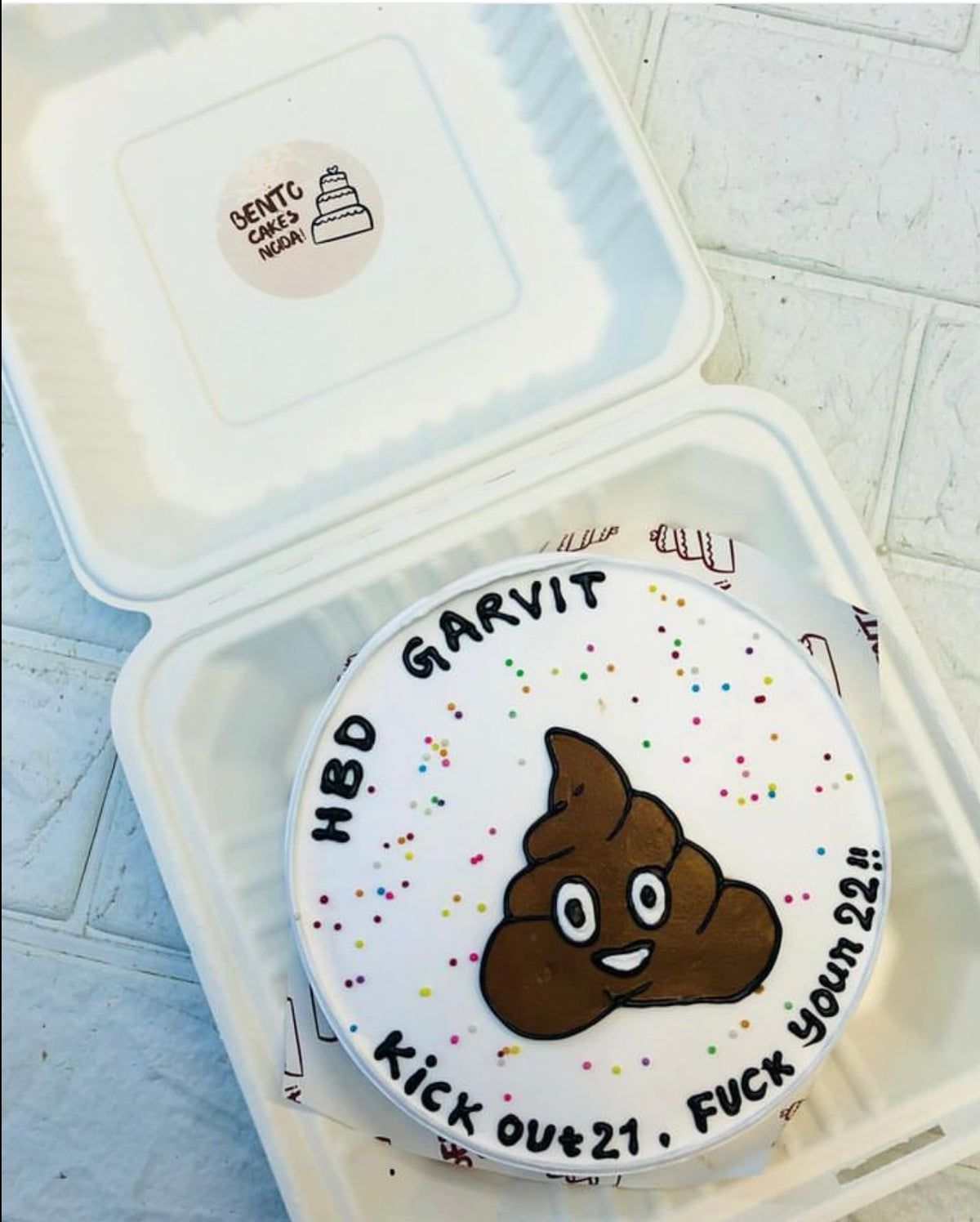 A white bento cake having ship design for birthday occasion.