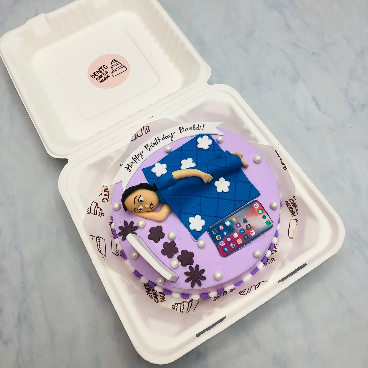 A sleepy girl theme purple bento cake decorated with whith sprinkles.