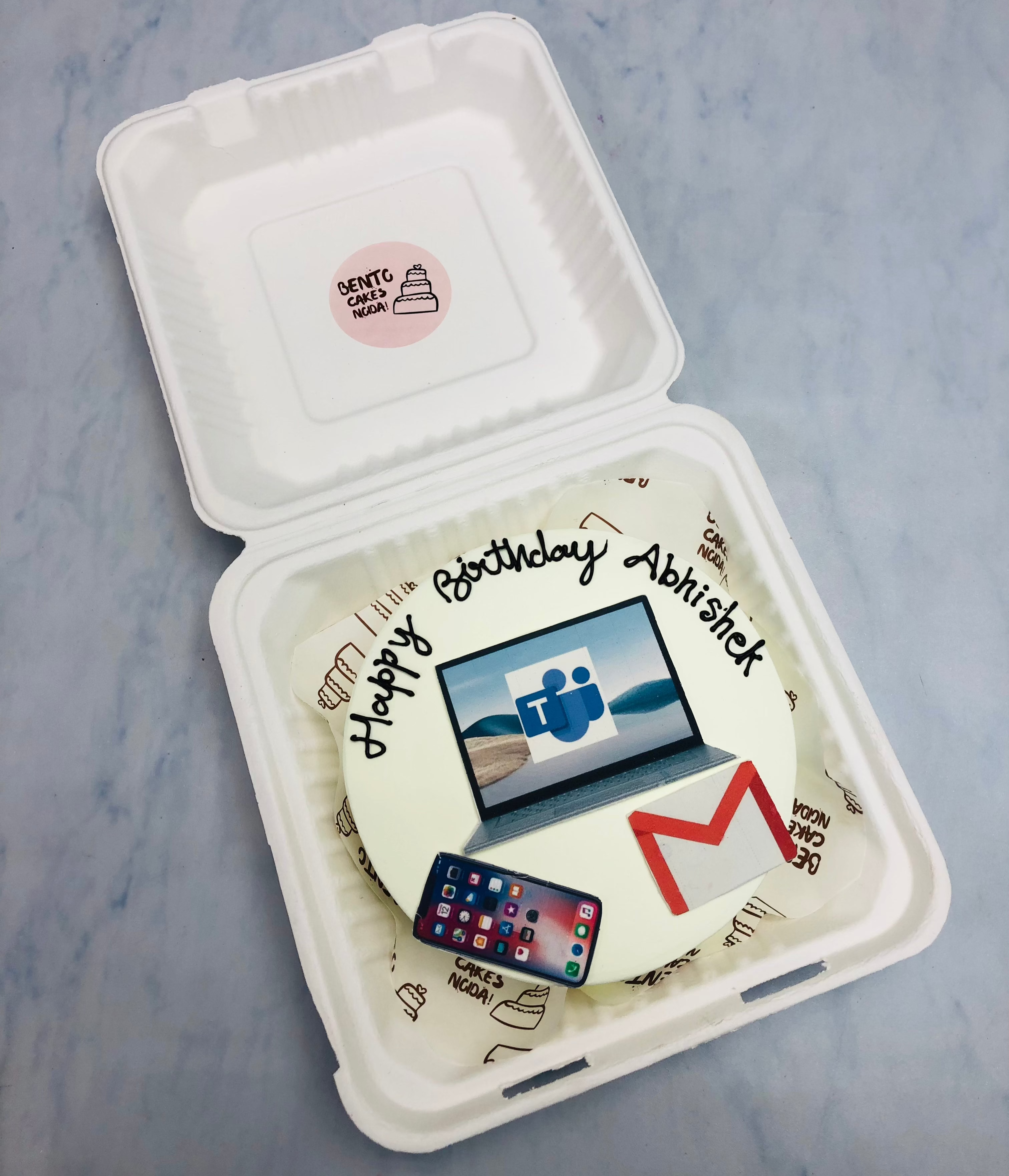 A white bento cake is designed for a social meria workaholi mens birthday.