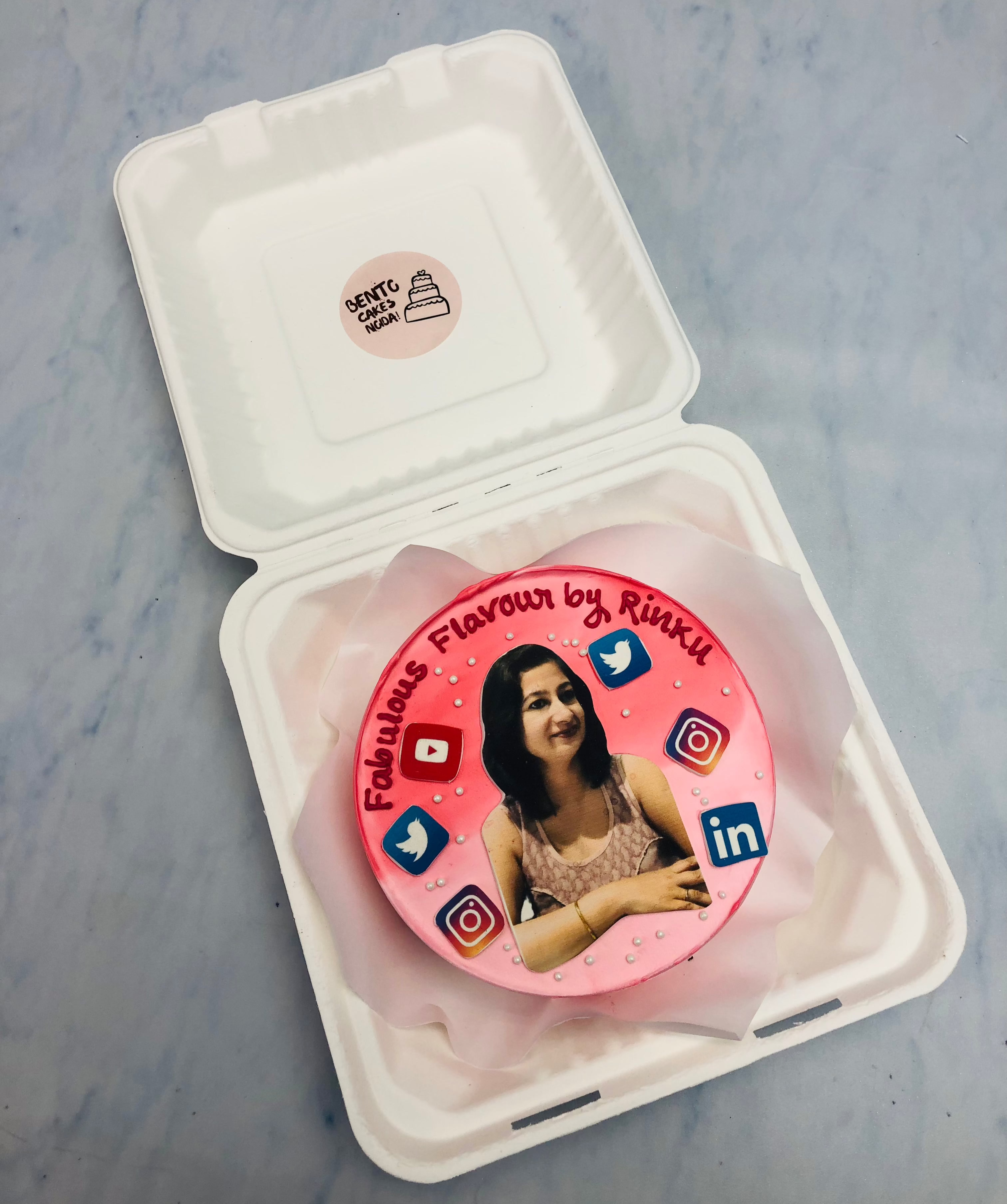 An aesthetic pink bento cake is designed for a social mredia addicted girls birthday with her photo on cake.