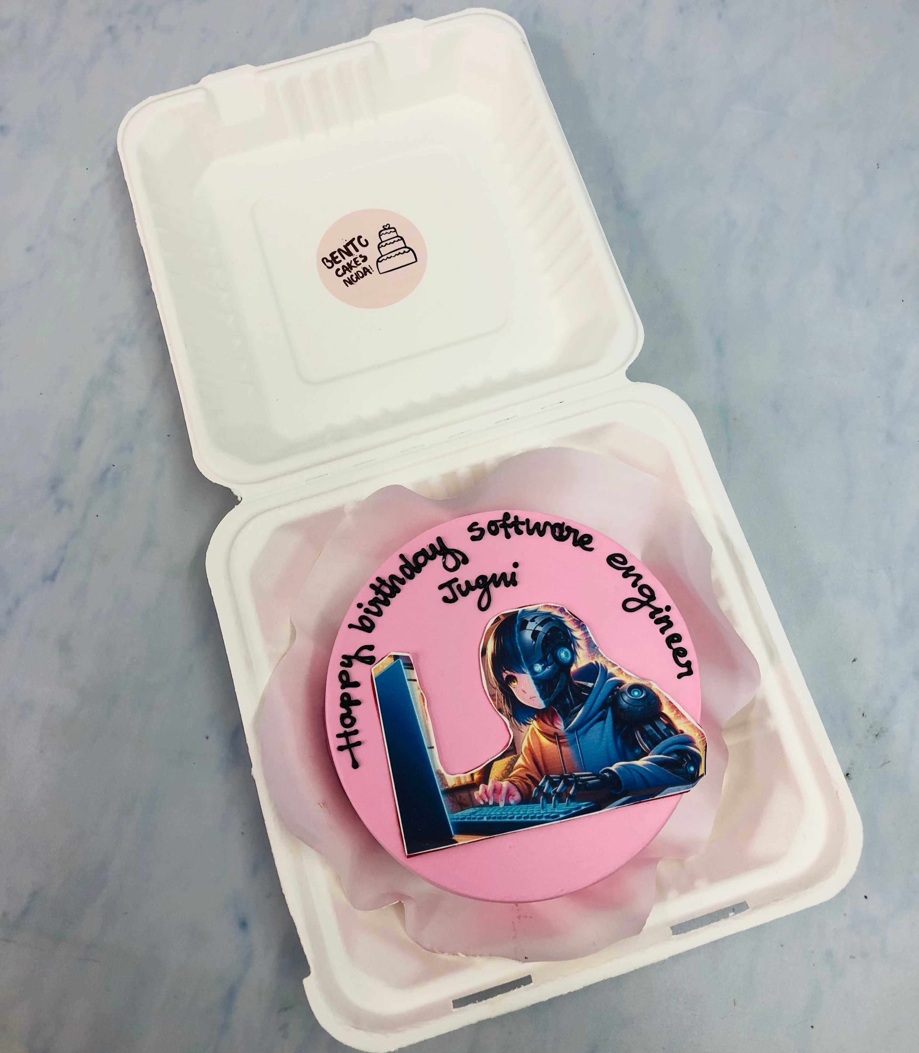 A light pink bento cake having a gamer's birthday theme.