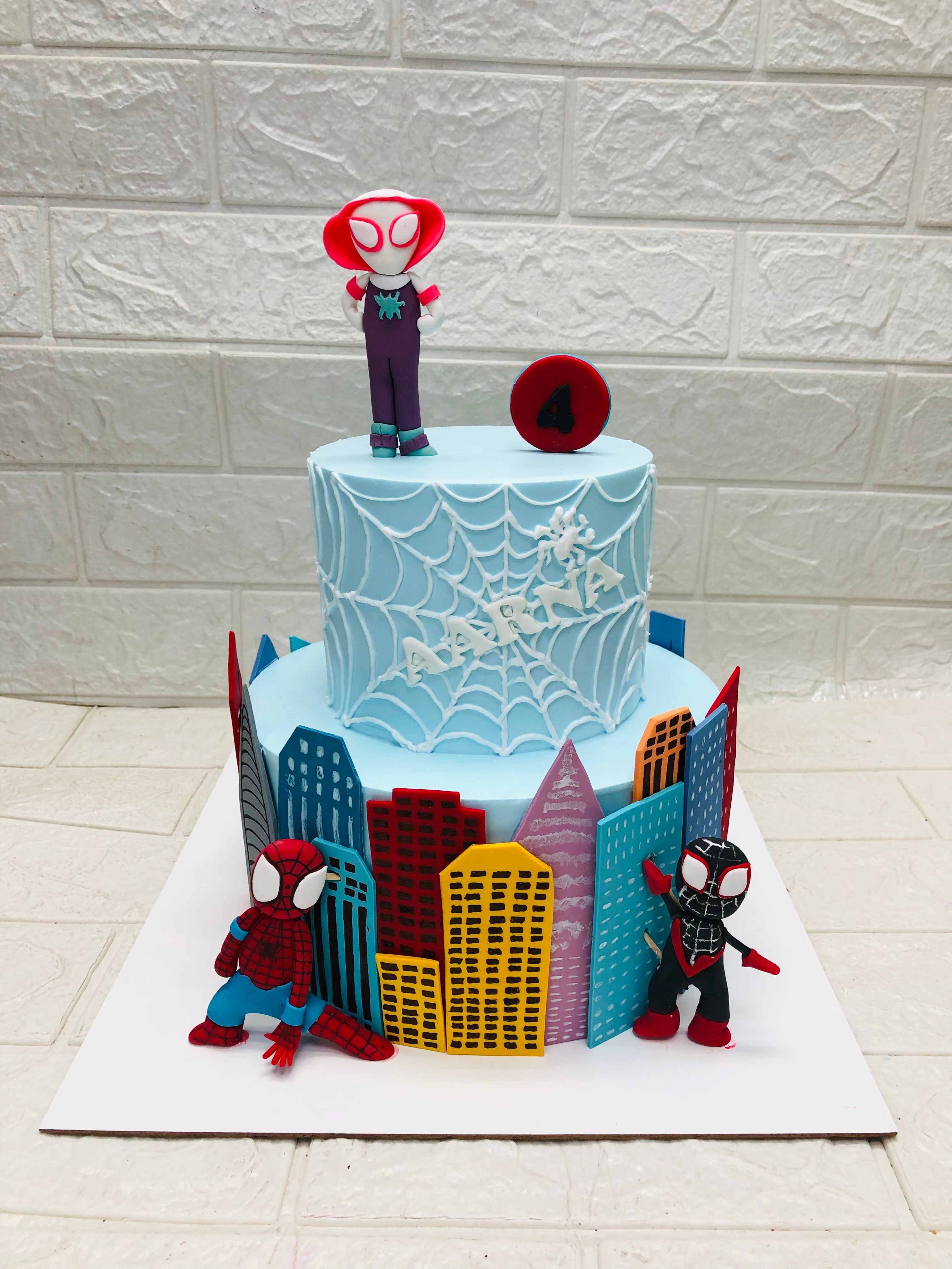 A Spider-Man themed cake featuring a detailed city skyline design, perfect for a superhero celebration.