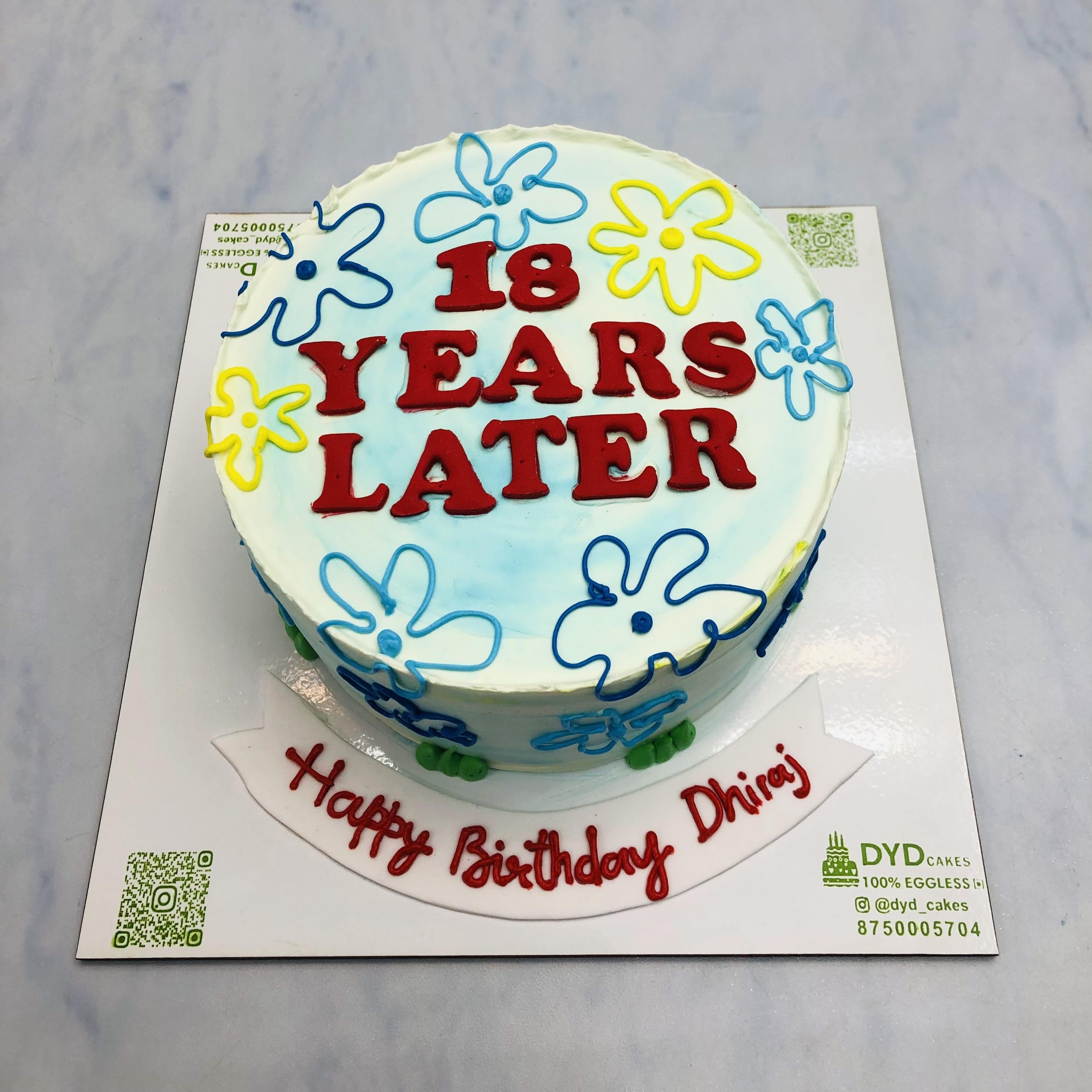 A white cake with spongebob cartoon theme for birthday.