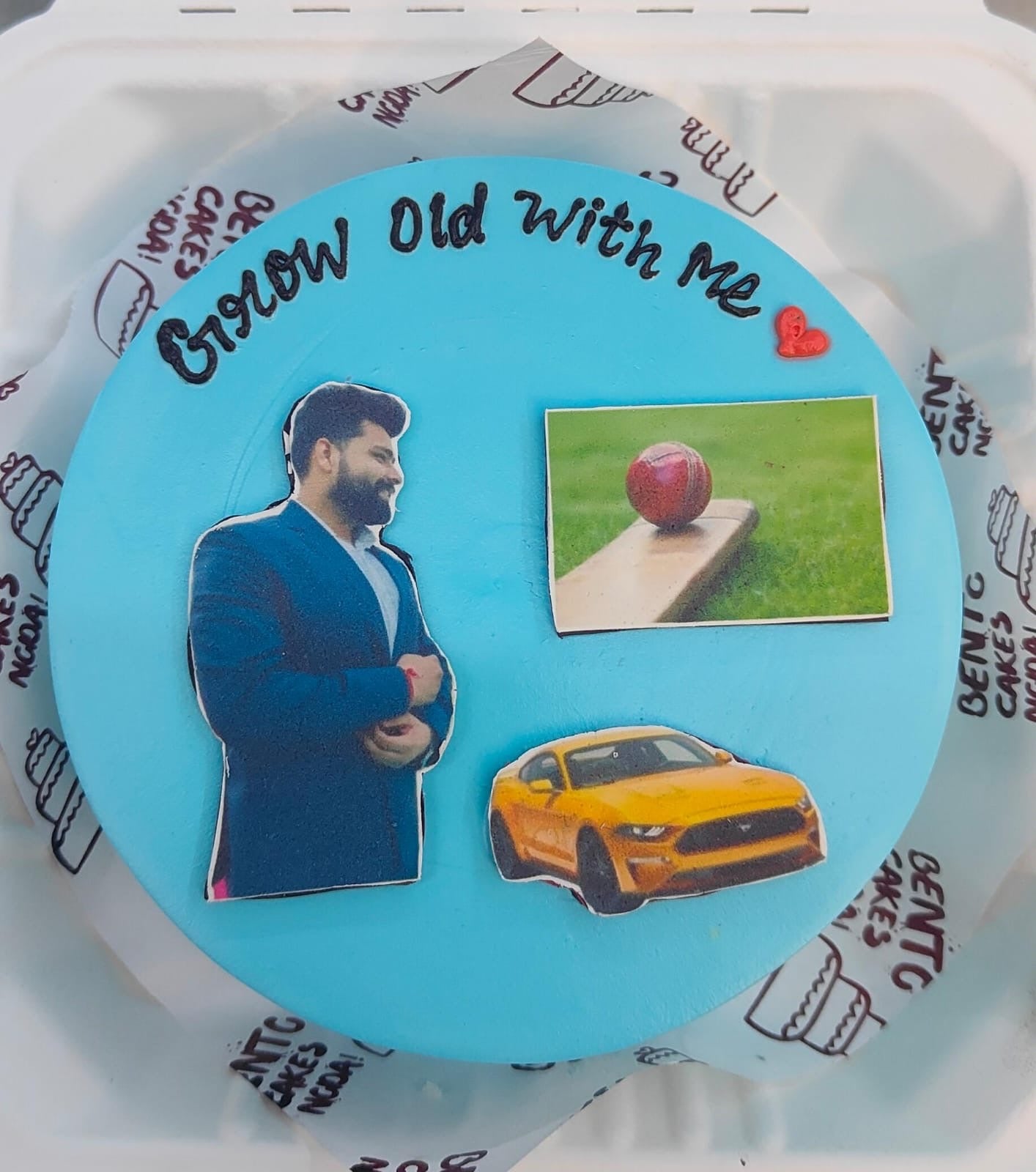 A sky blue bento cake with luxury car, sports and a person print on the cake.