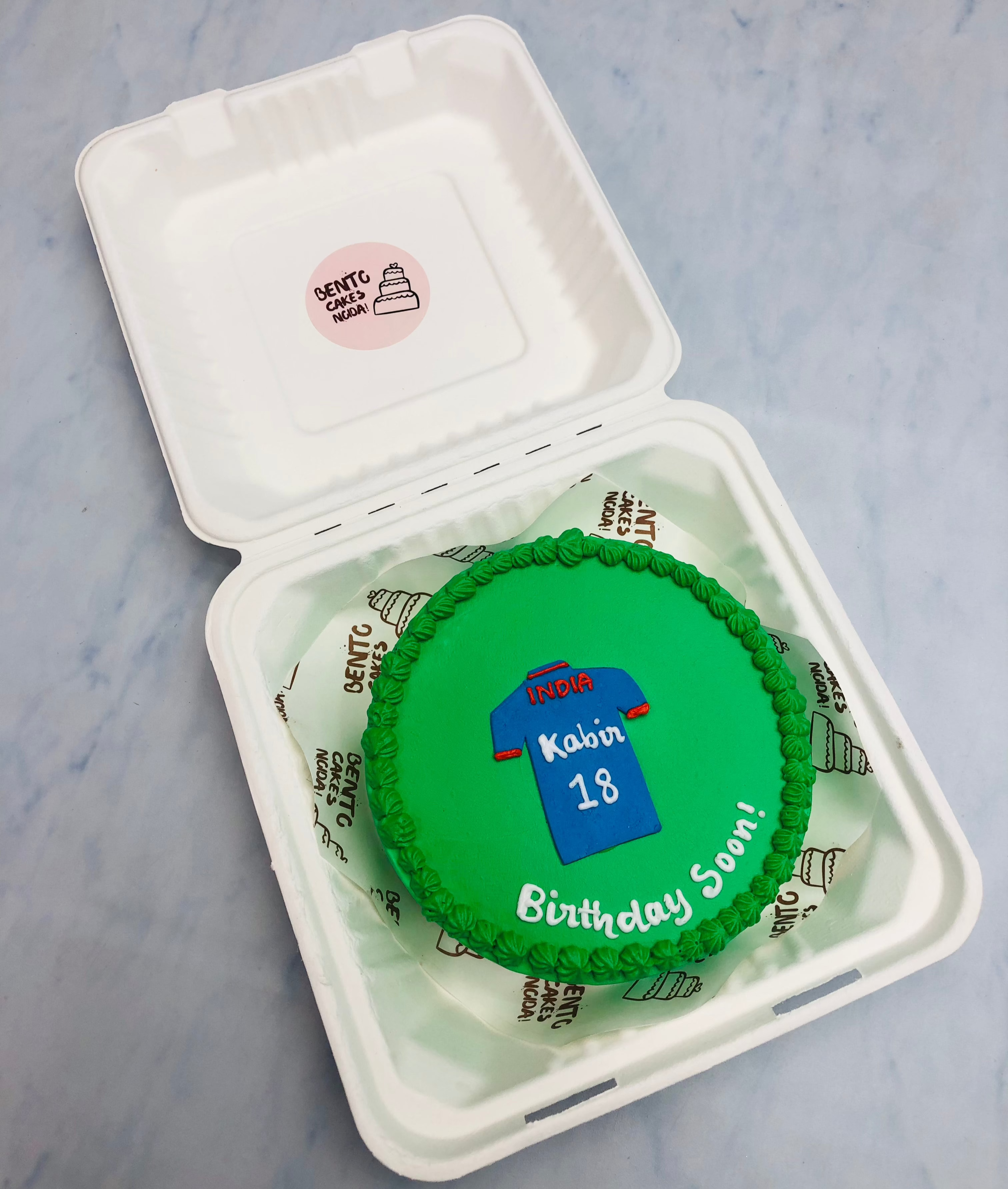 A green bento cake designed on cricketer tshirt theme for his birthday.