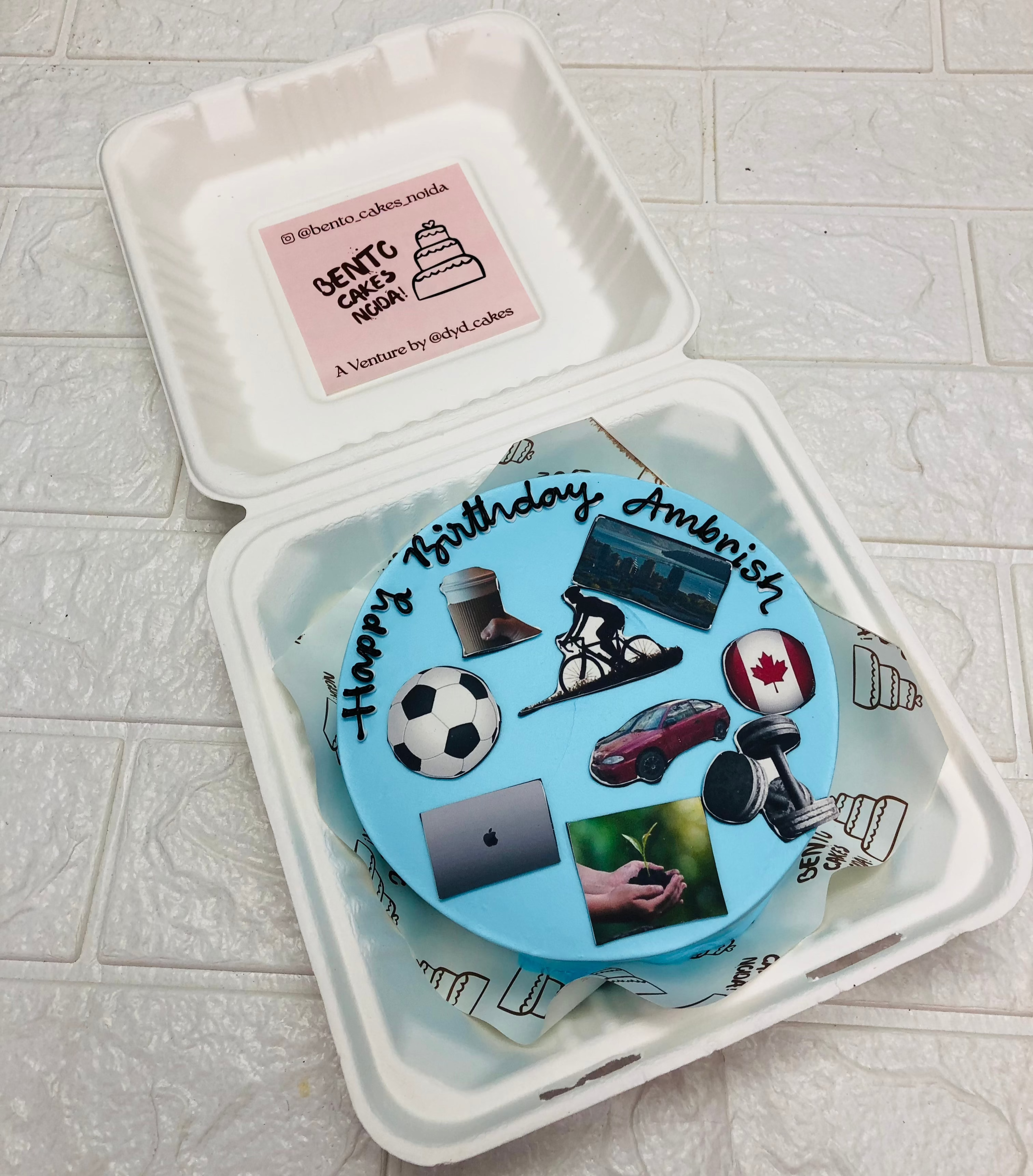 A light blue bento cake designed for different sports lovers mens birthday.