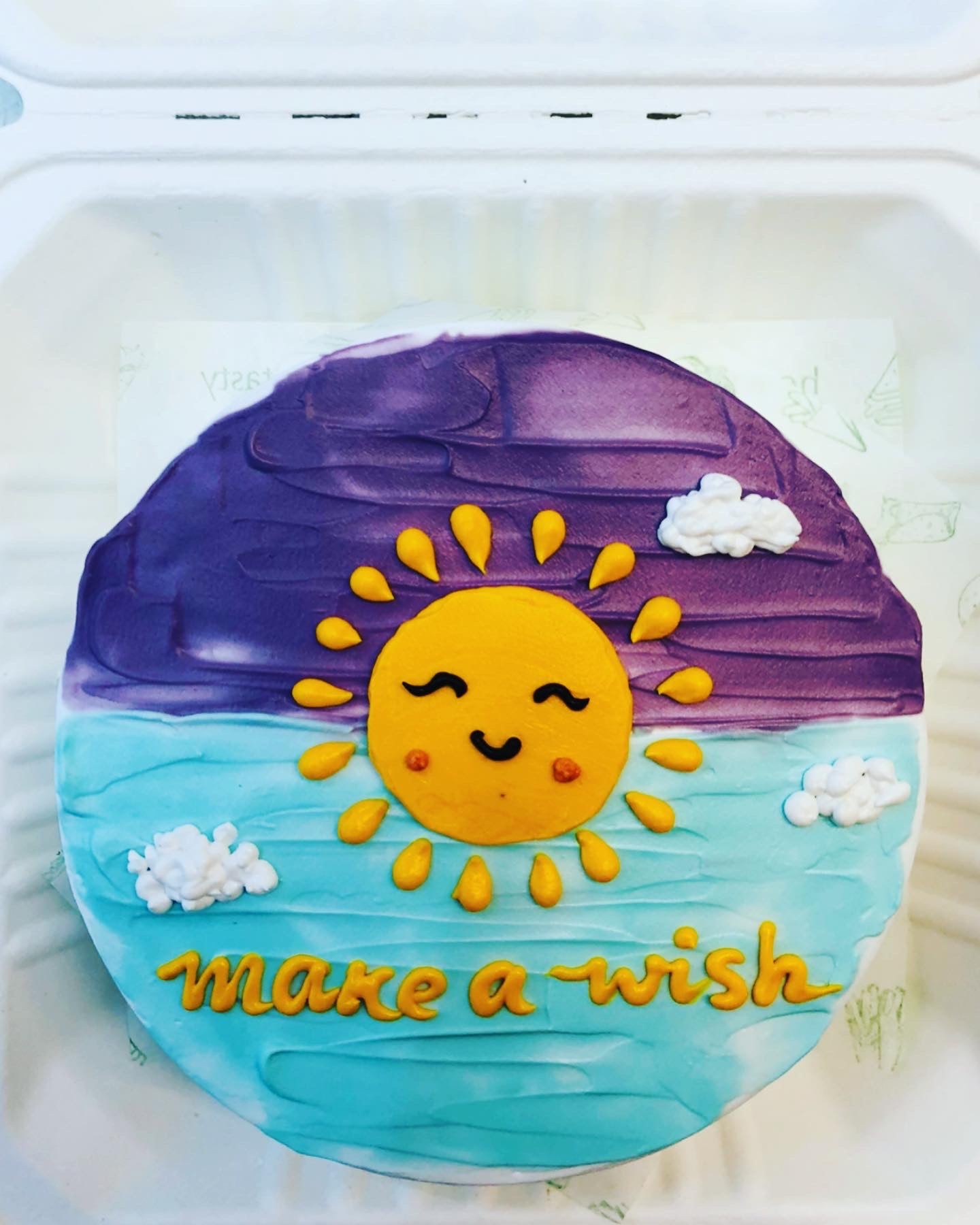 A beautifully decorated cake featuring the phrase "Make a Wish" elegantly written on top.