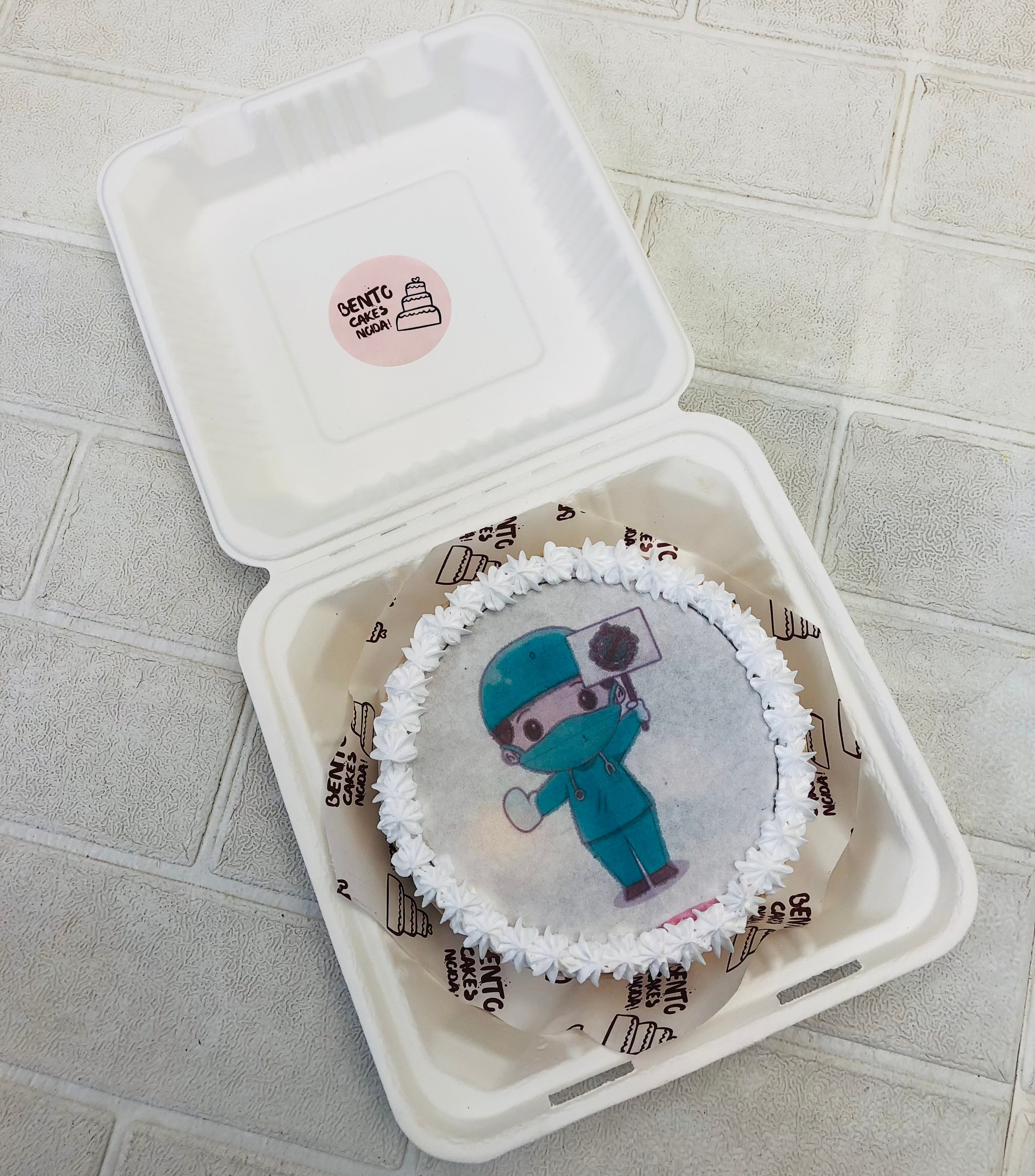 A fire paper designed with a surgeon doctor on a white fire bento cake.