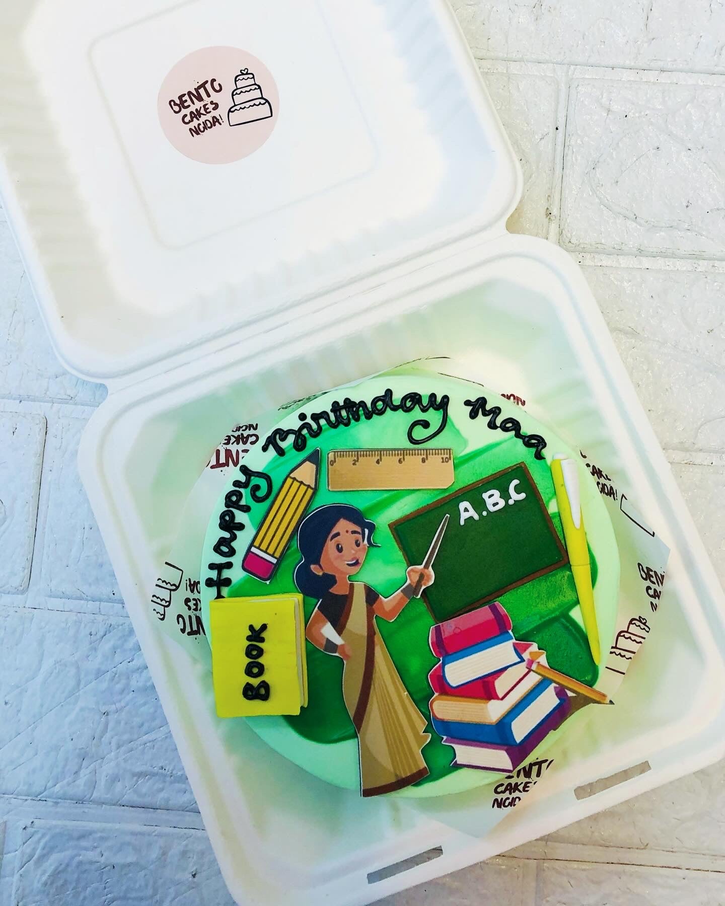 A lime green bento cake with green shades on it for a teacher mom teaching in a classrom.