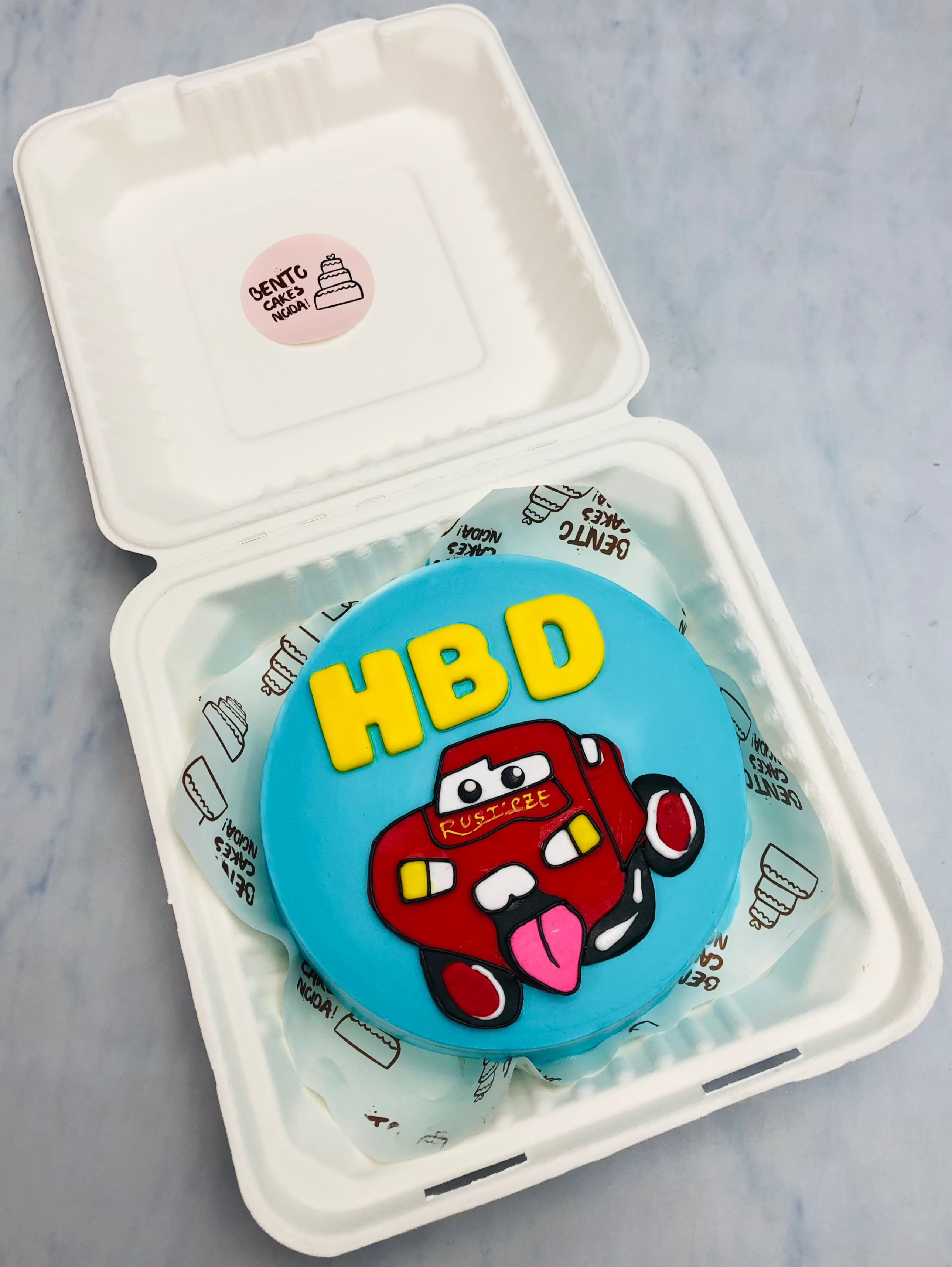 A light blue bento with a MC Car cartoon print.