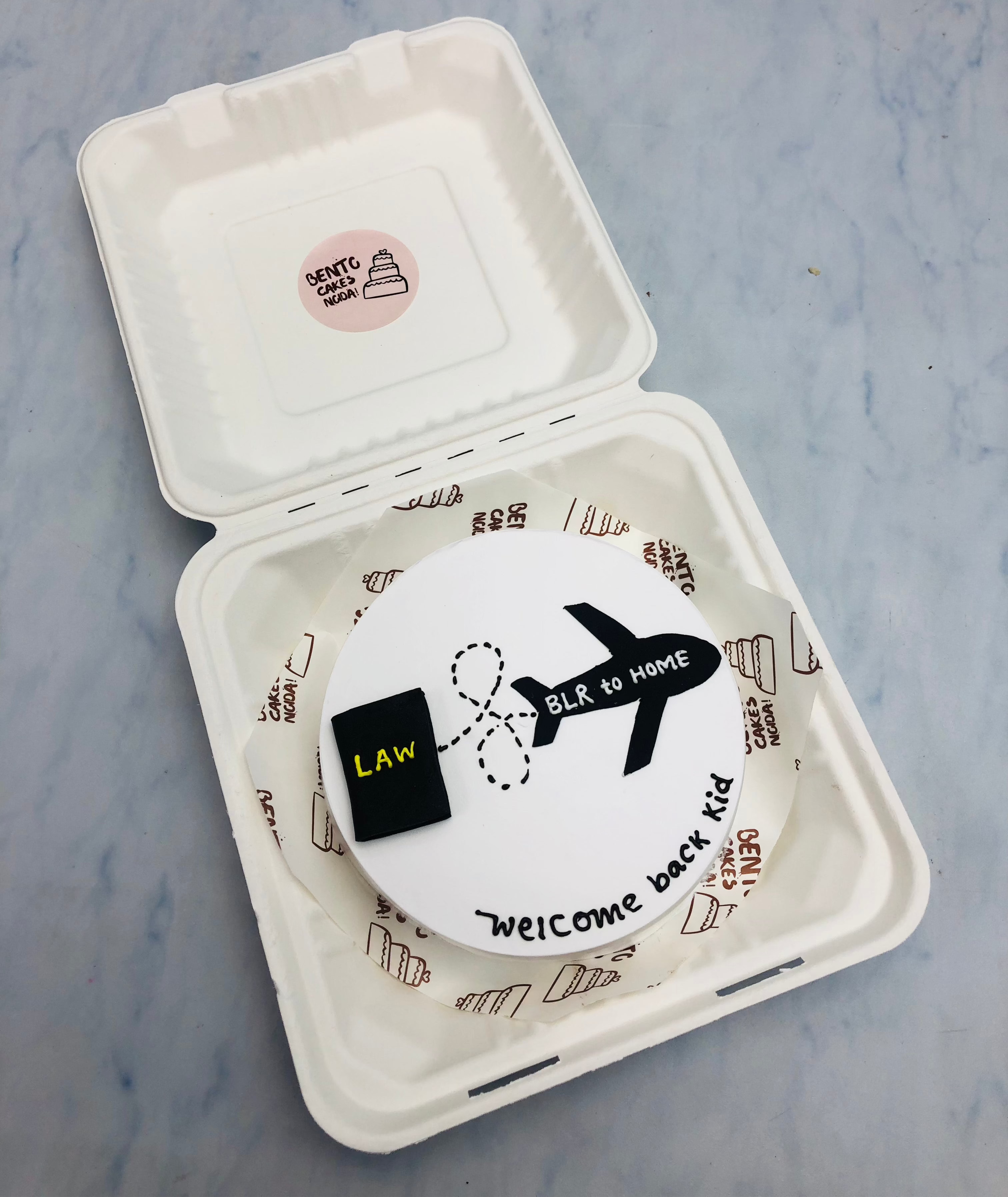 A kid coming from abroad to home theme white bento cake.