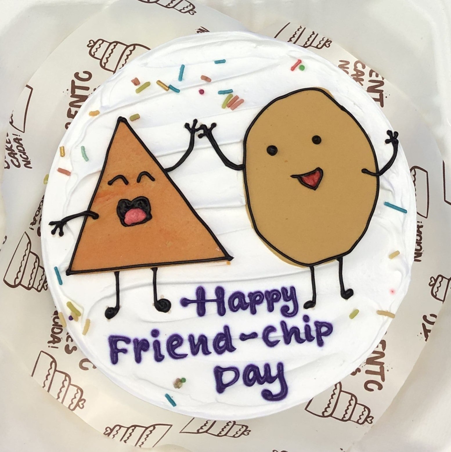 A white bento cake with triangle and circle design celebrating friendship day together.