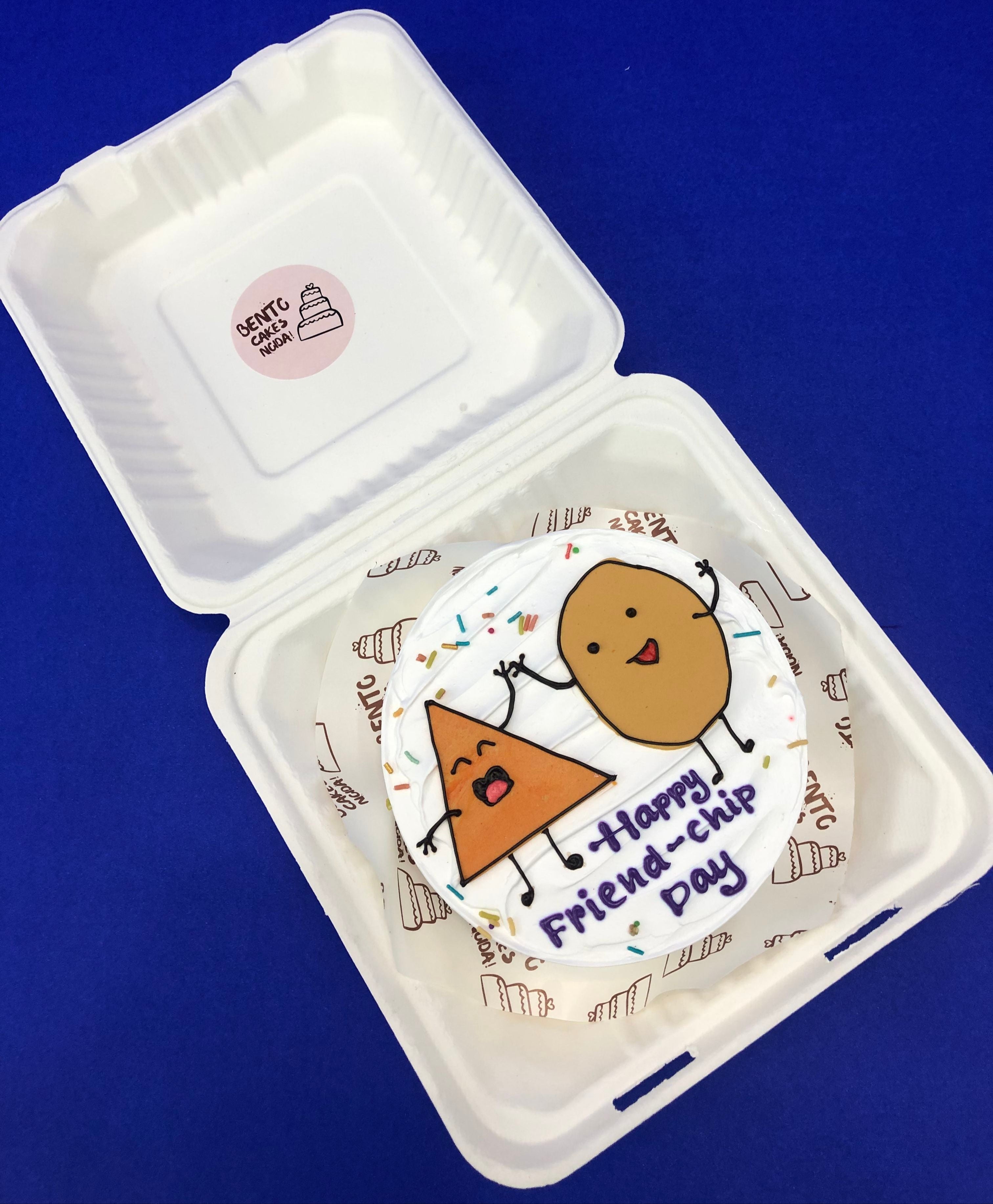 A white bento cake with triangle and circle design celebrating friendship day together.
