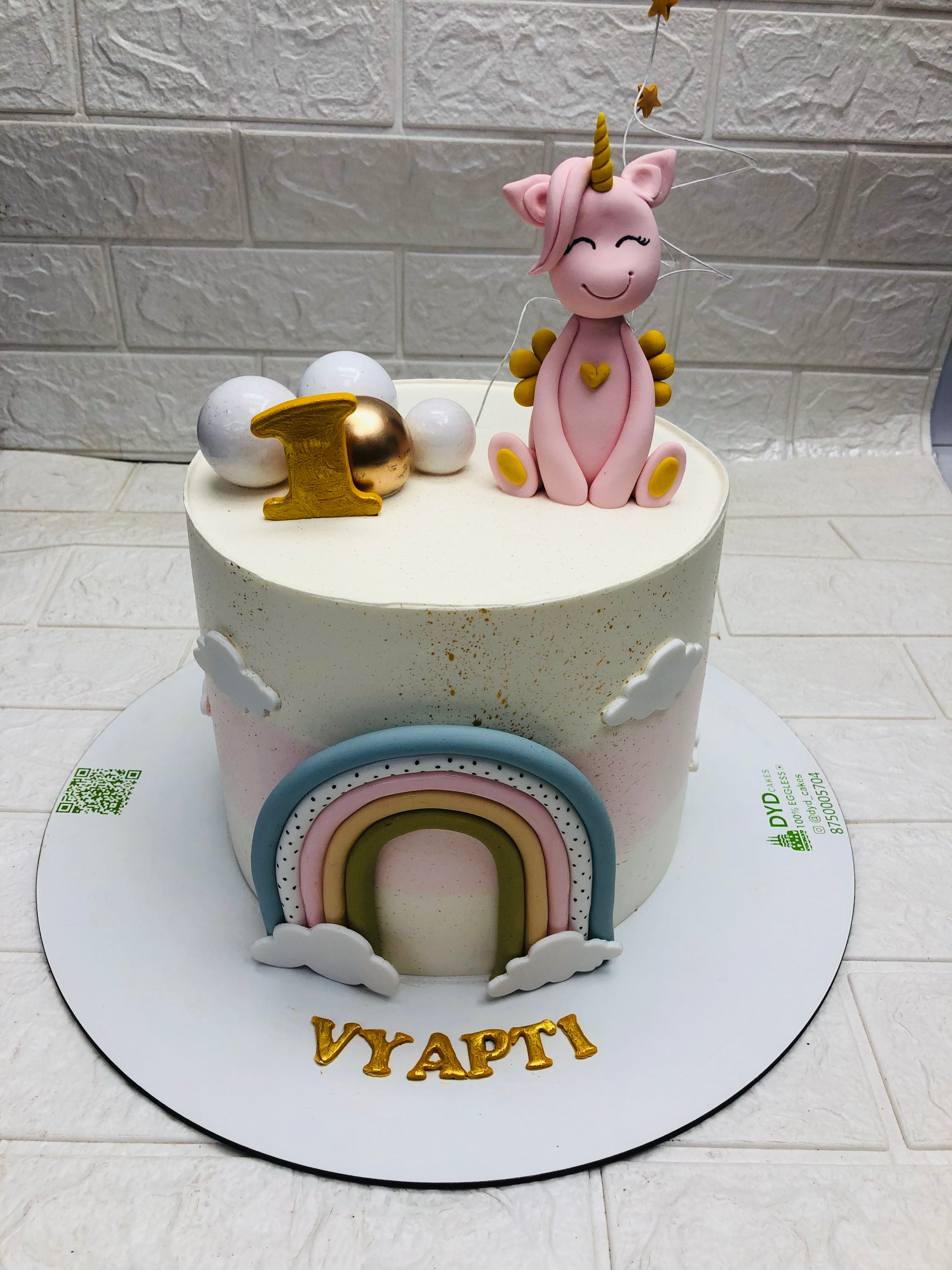 A whimsical cake adorned with a unicorn and a rainbow, bringing a touch of magic to any celebration.