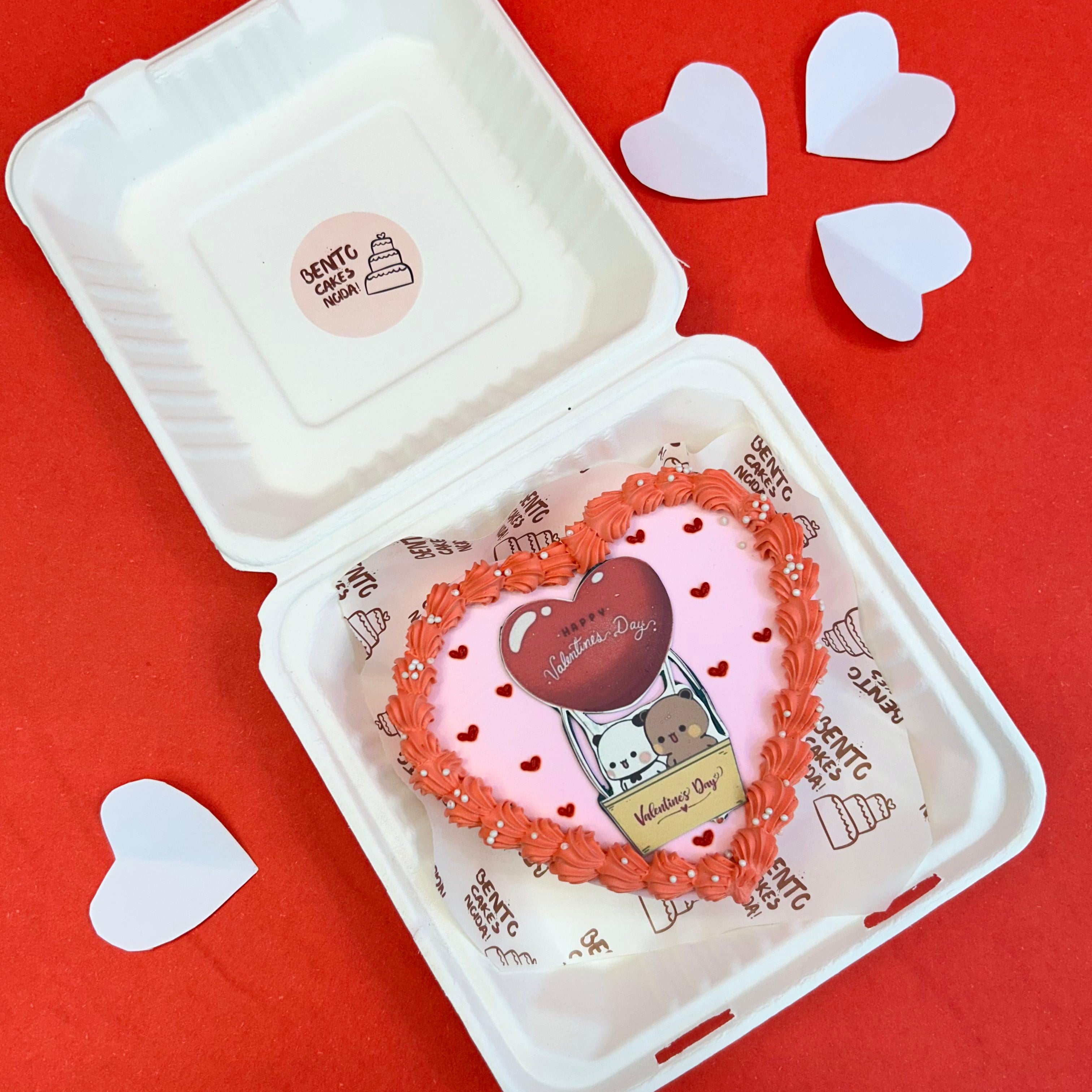 A heart-shaped cake in a bento box, featuring the Bubu Dudu cartoon character, perfect for Valentine's Day.