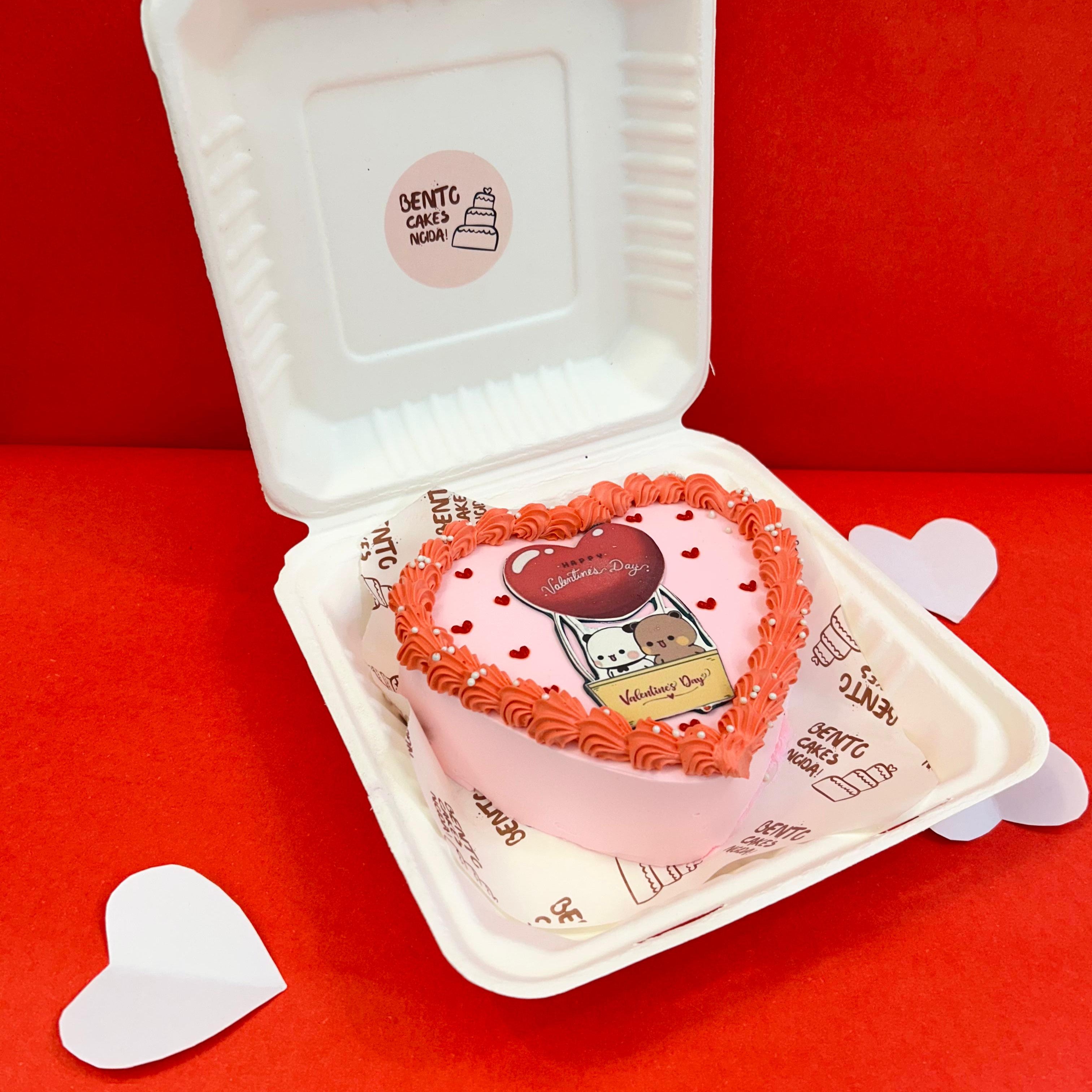 A heart-shaped cake in a bento box with side face, featuring the Bubu Dudu cartoon character, perfect for Valentine's Day.