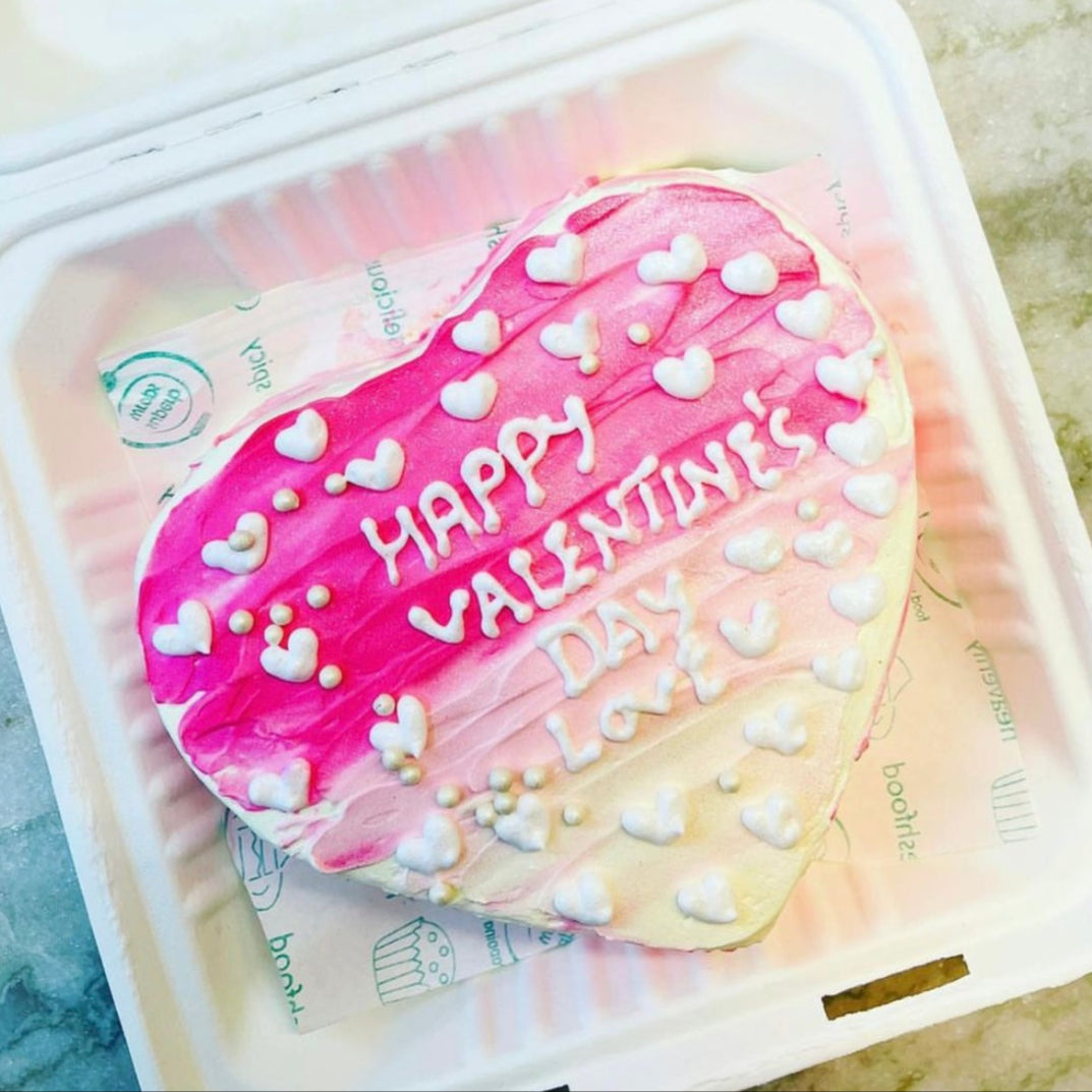 A heart-shaped cake beautifully presented in a bento box, perfect for celebrating love and special occasions.