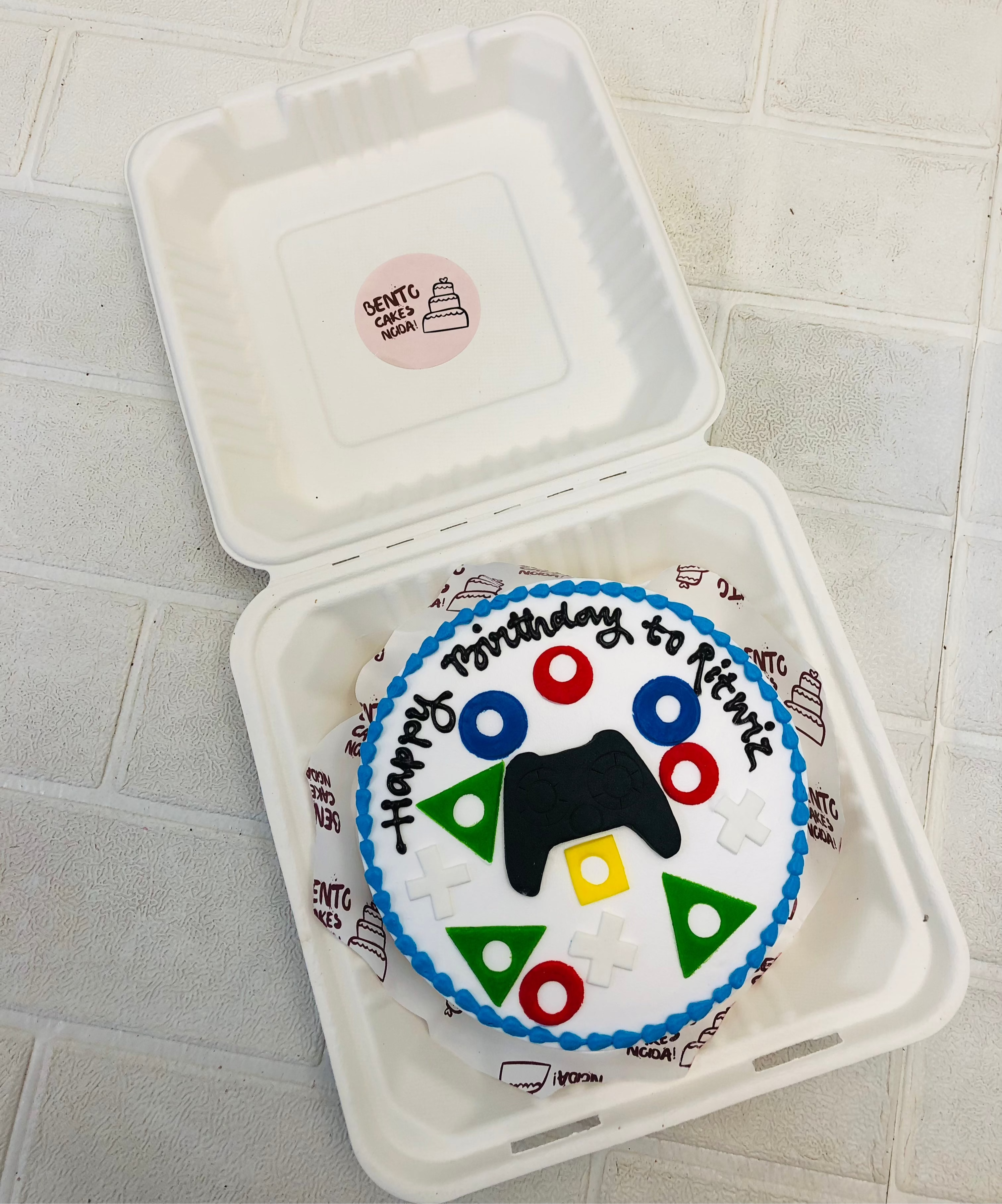 A white bento cake designed for gaming lovers birthday theme.