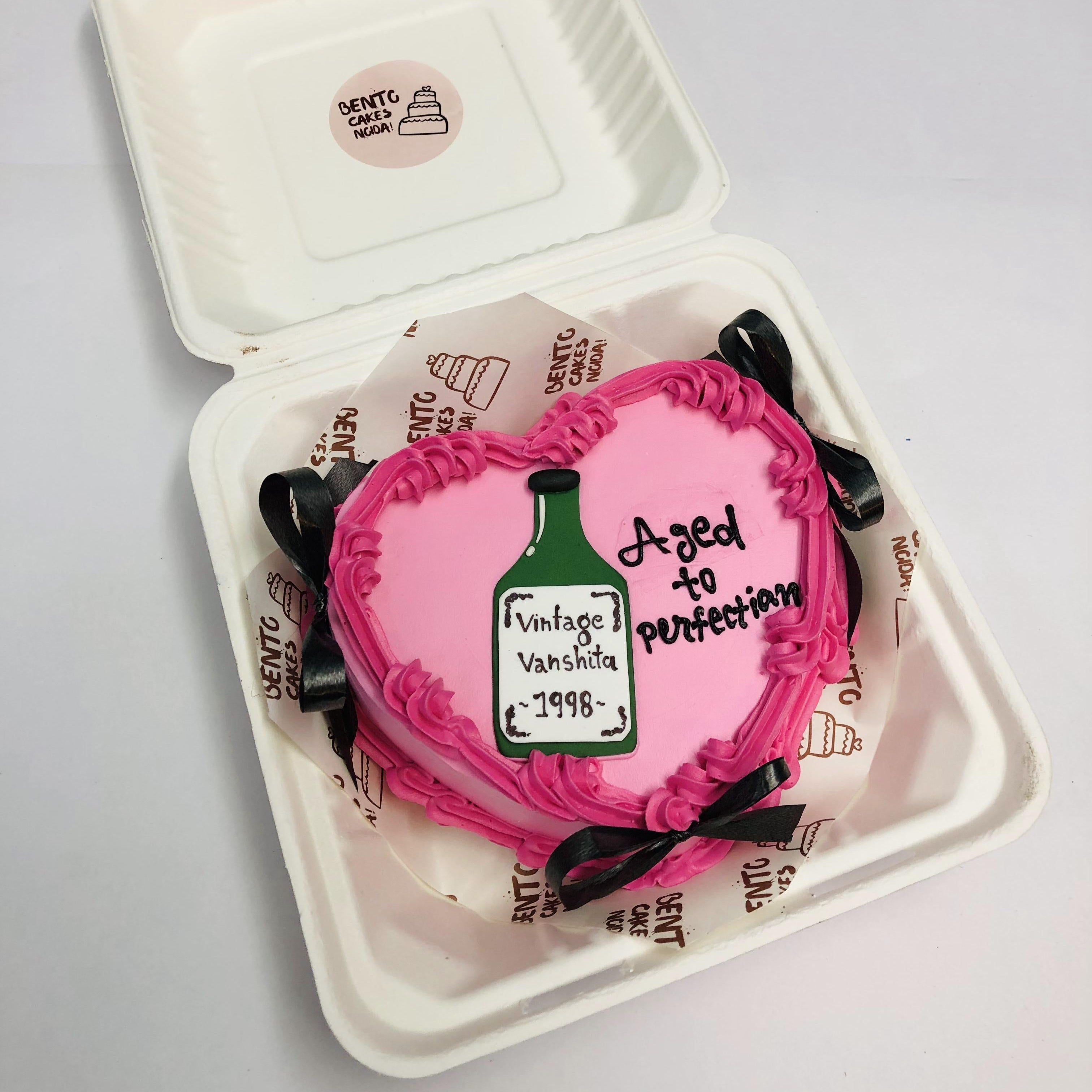 A Vintage Theme Heart Bento Cake with black bows and a bear boyyle rint on it.