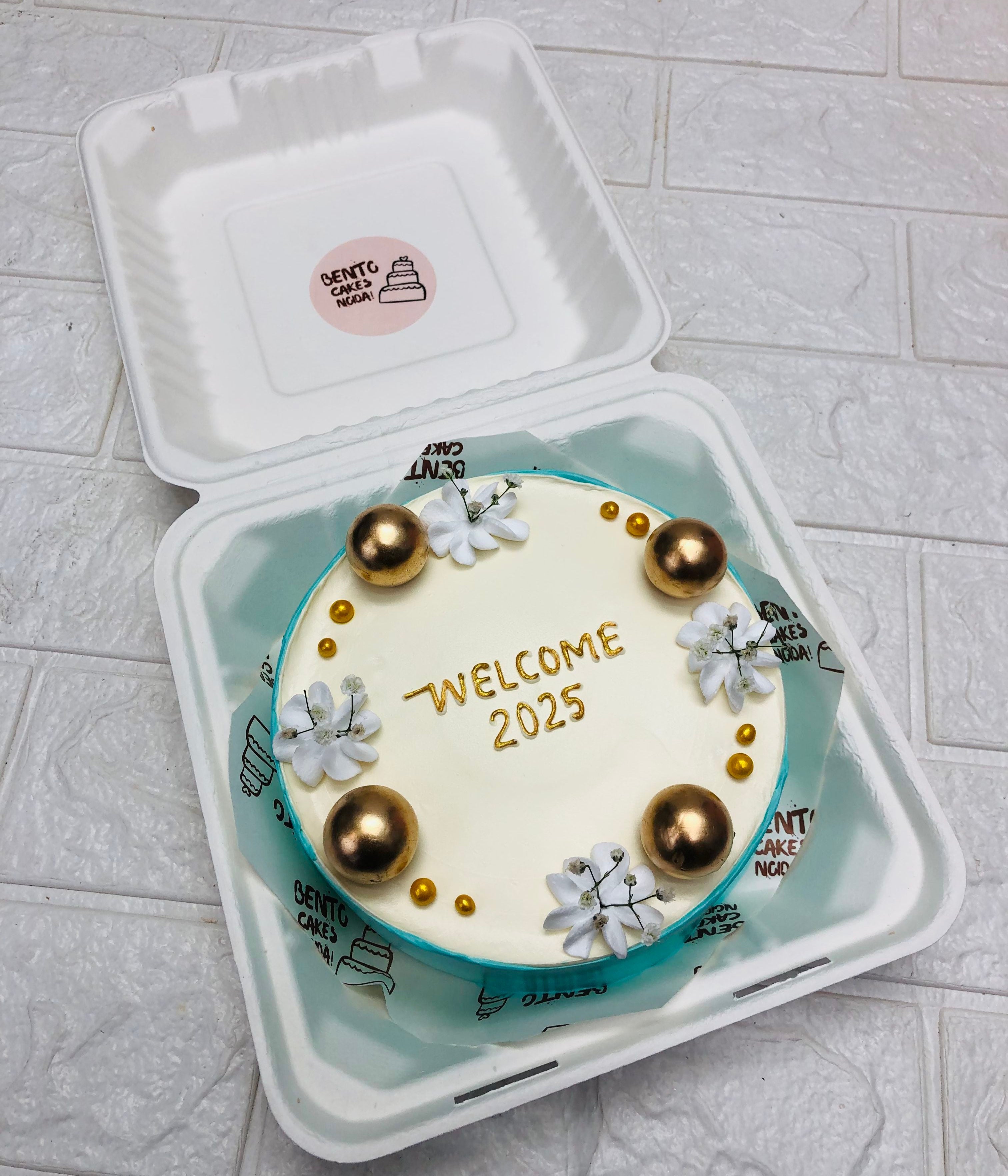 An aesthetic floral and golden balls bento cake designed for new year celebration.