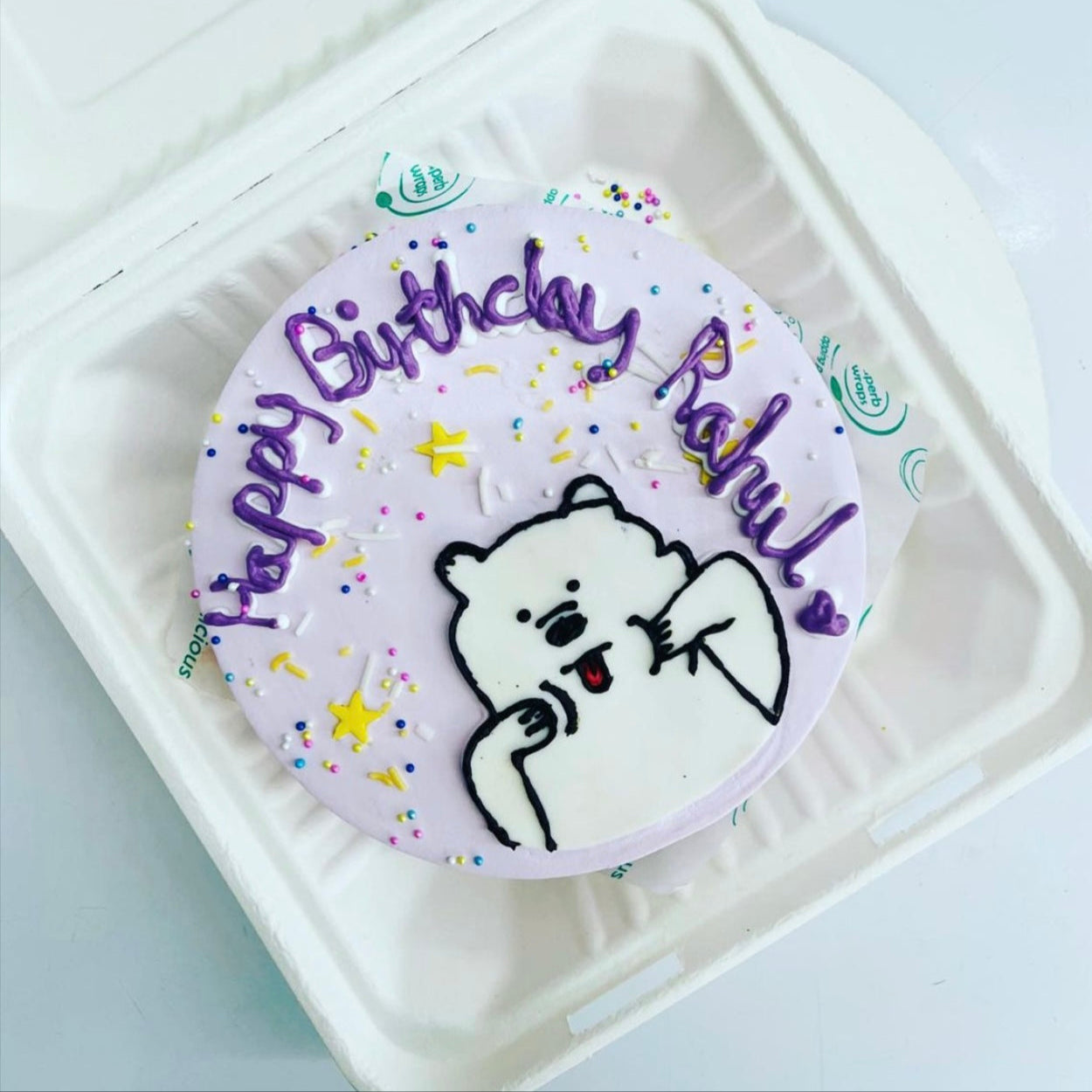 A festive birthday cake adorned with a cute white bear on top, celebrating a special occasion.