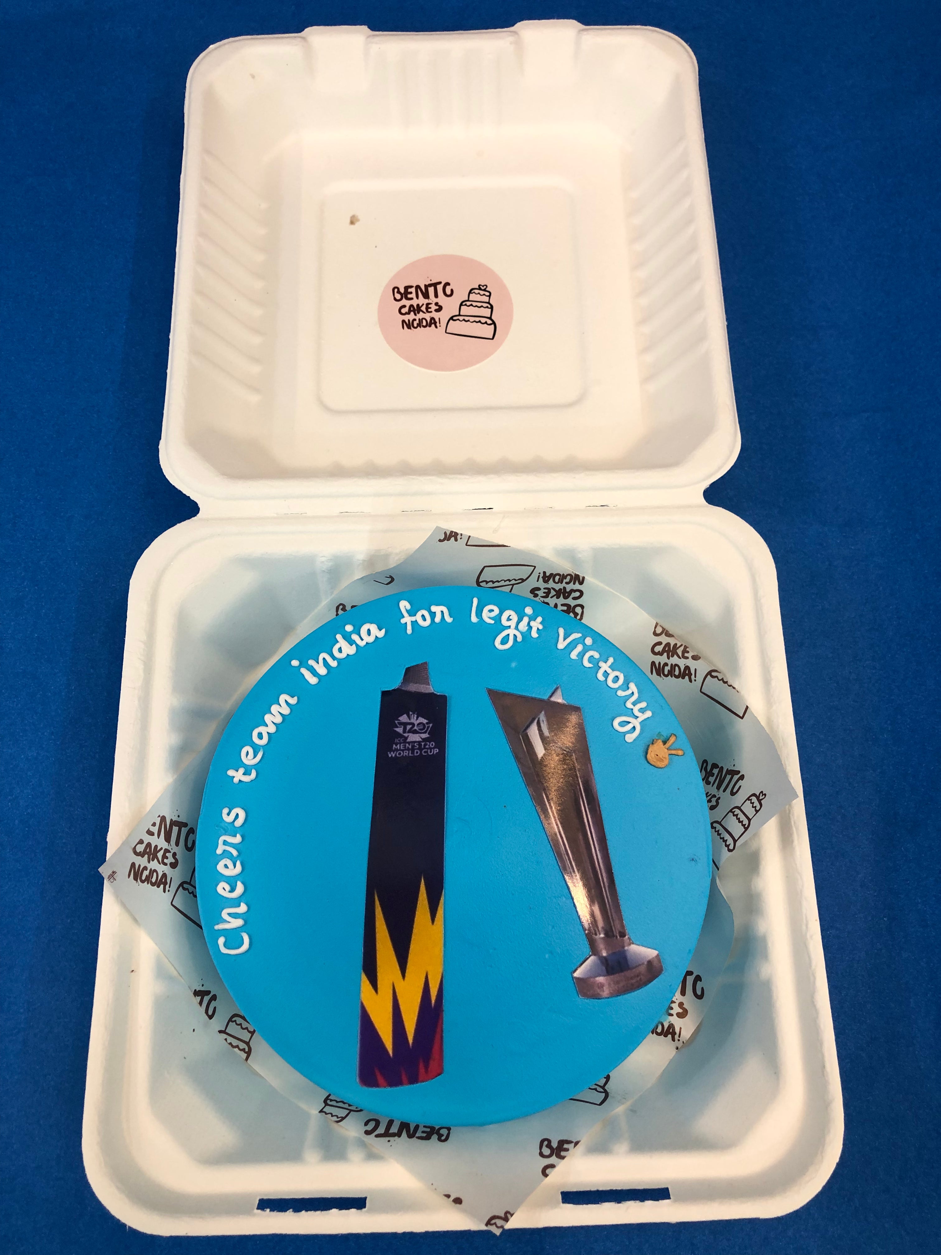 A blue bento cake with winning troppy theme for celebrating team india victory.