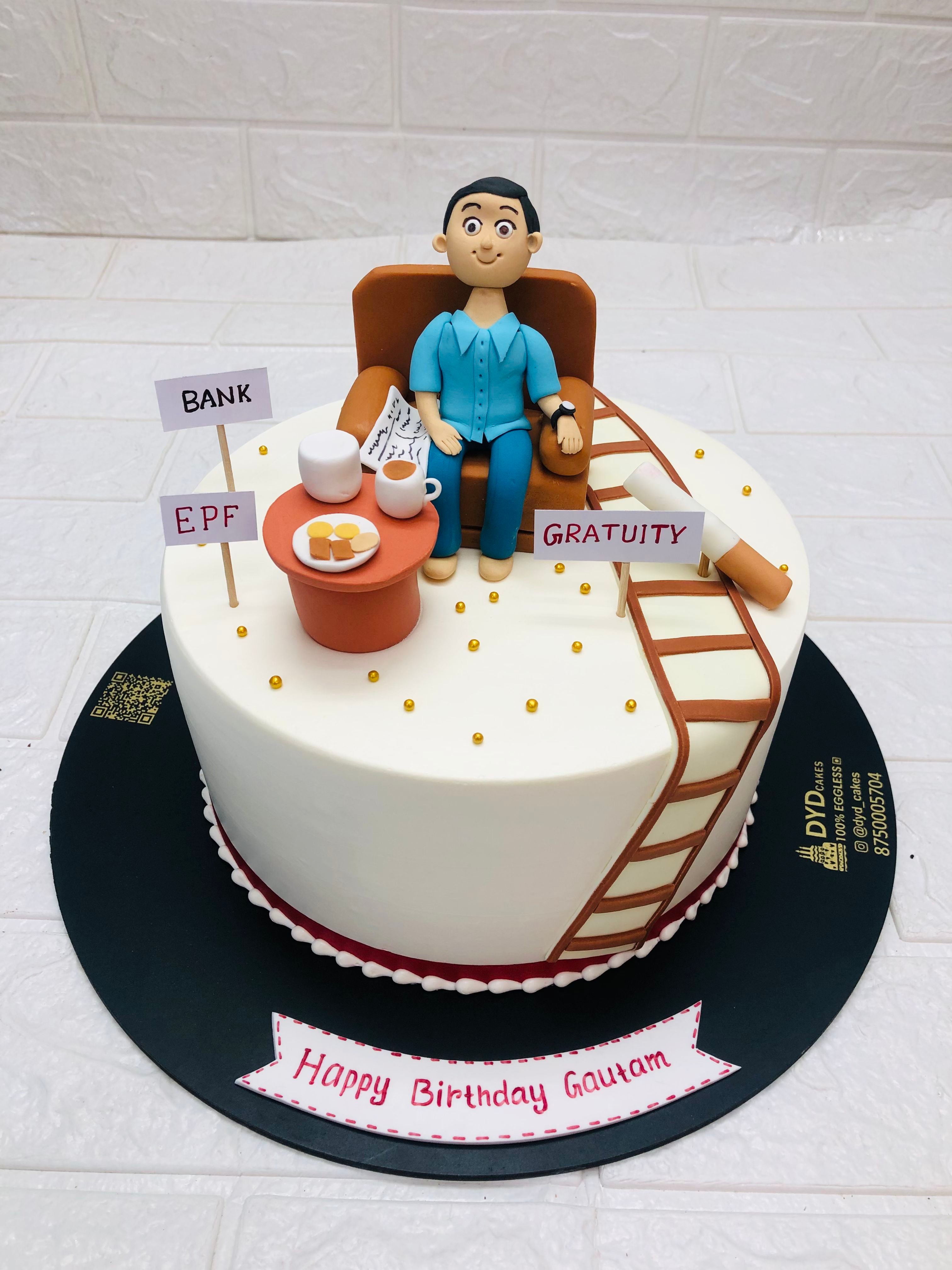 A birthday cake is present as a man in a chair taking Tea and biscuits, engaged in newspaper for the festive occasion.