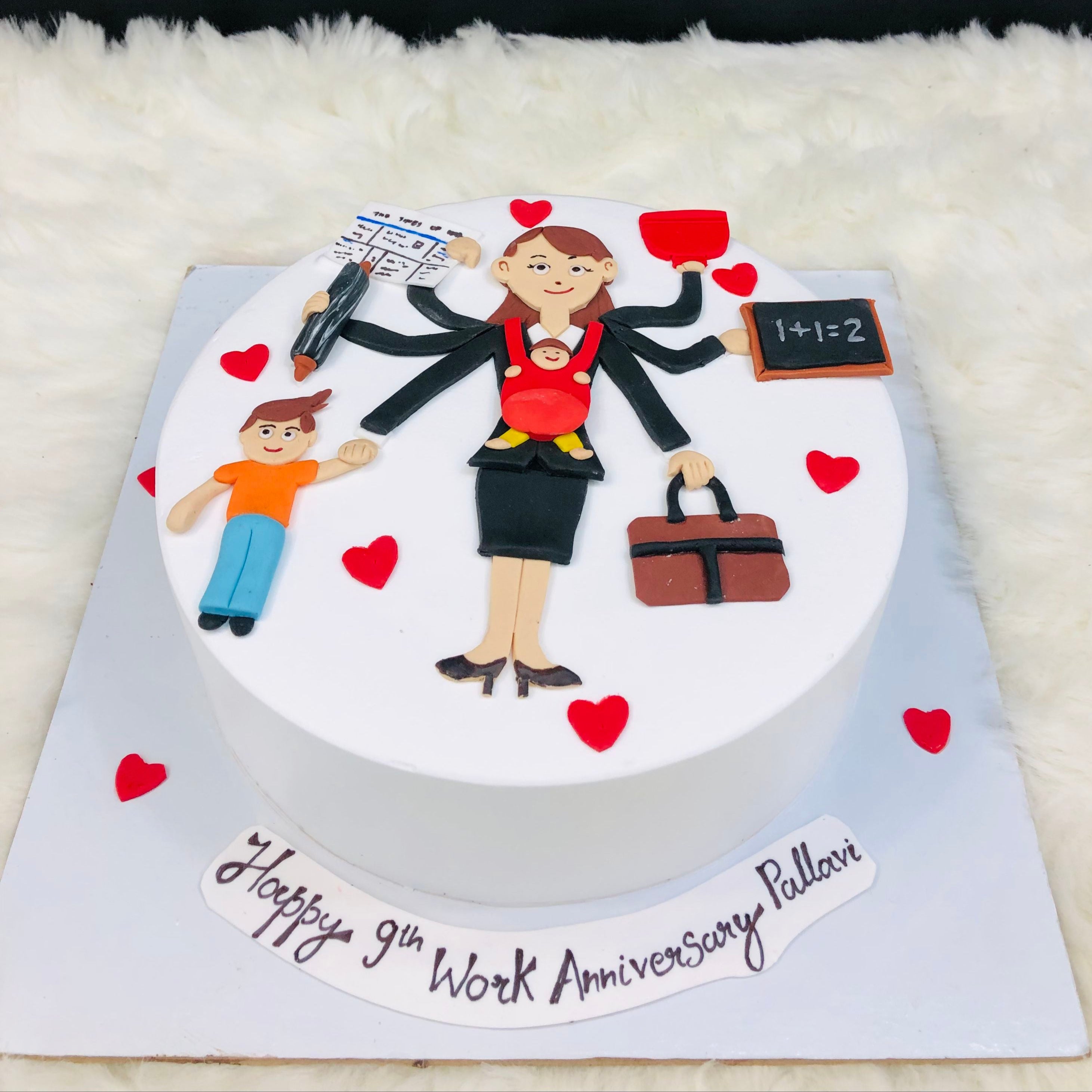 A joyful woman holds a child beside a heart-shaped cake, celebrating love and family moments together.