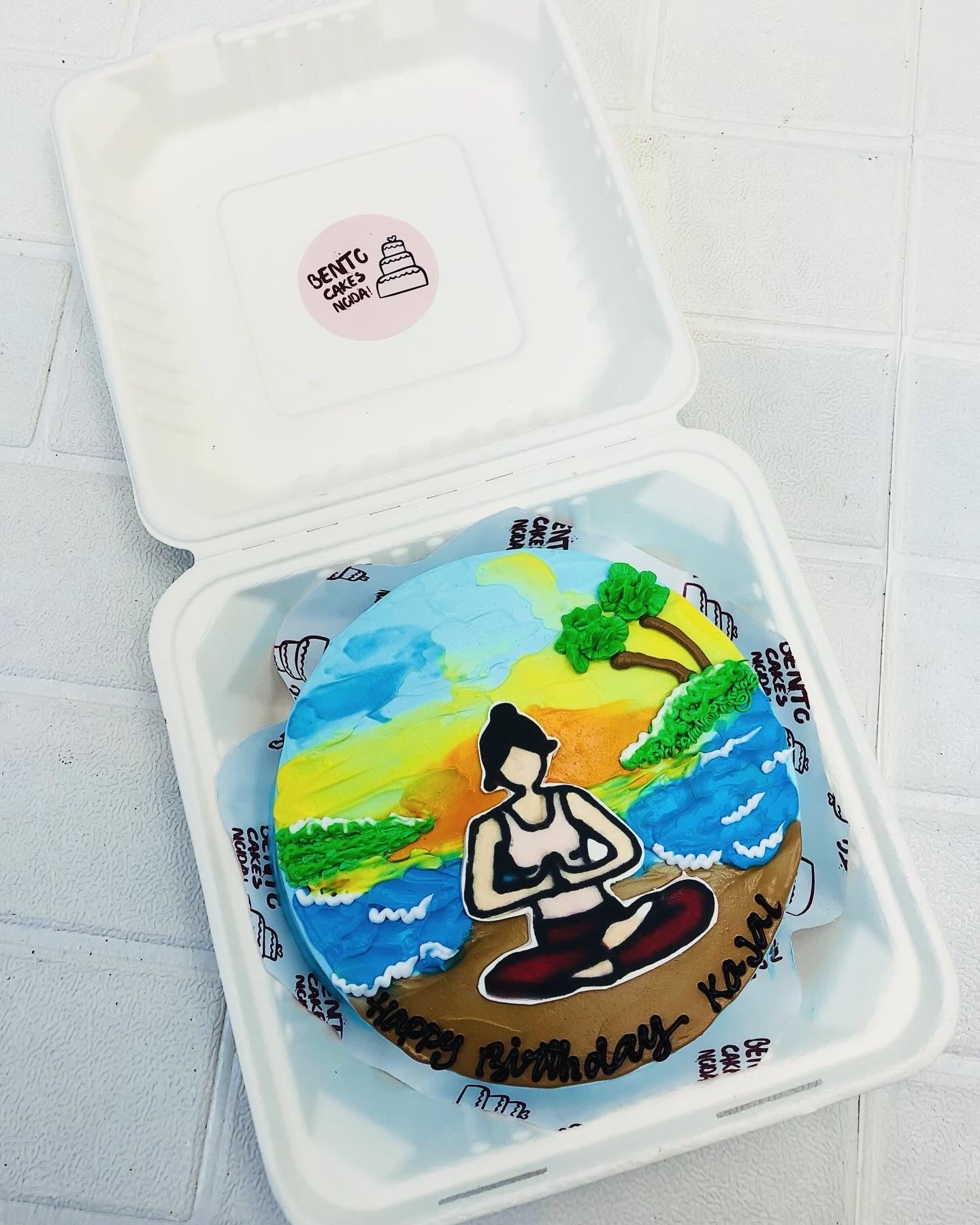 Aesthetic bento cake designed with a yoga girl in mediation posture on the side of river.