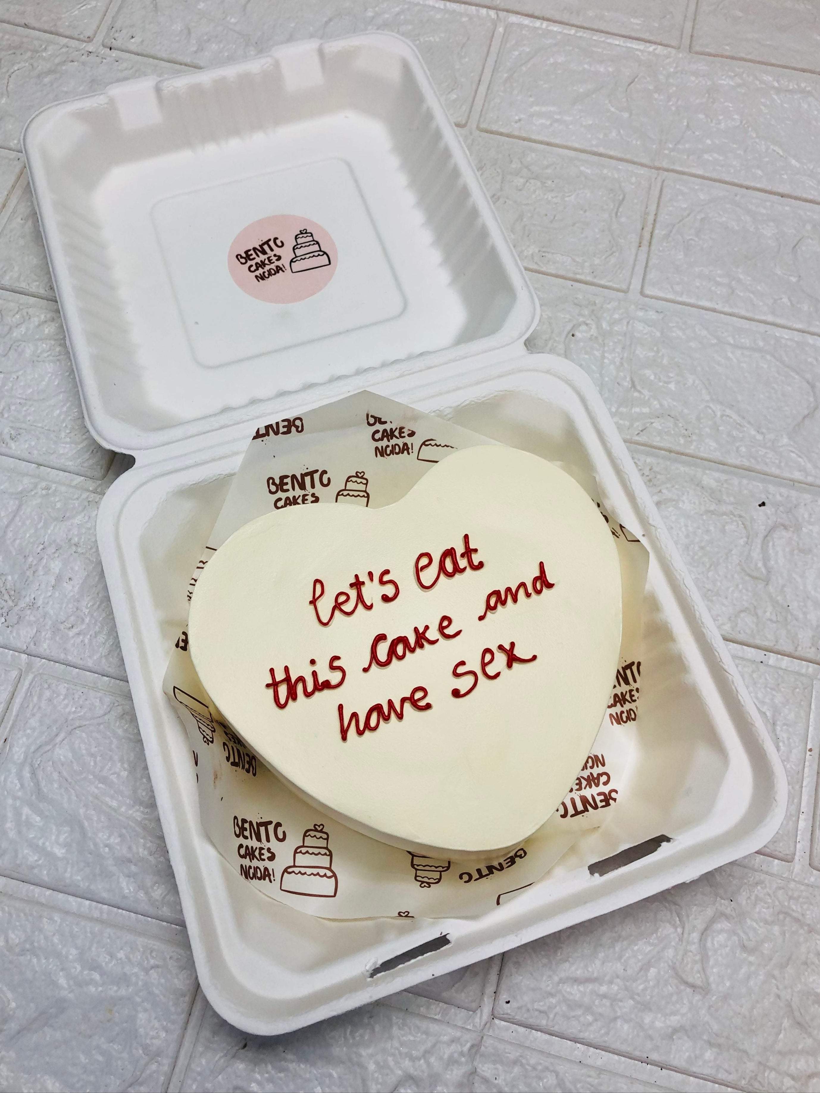 A custom message heart bento cake With a bacheloratte text written on it.